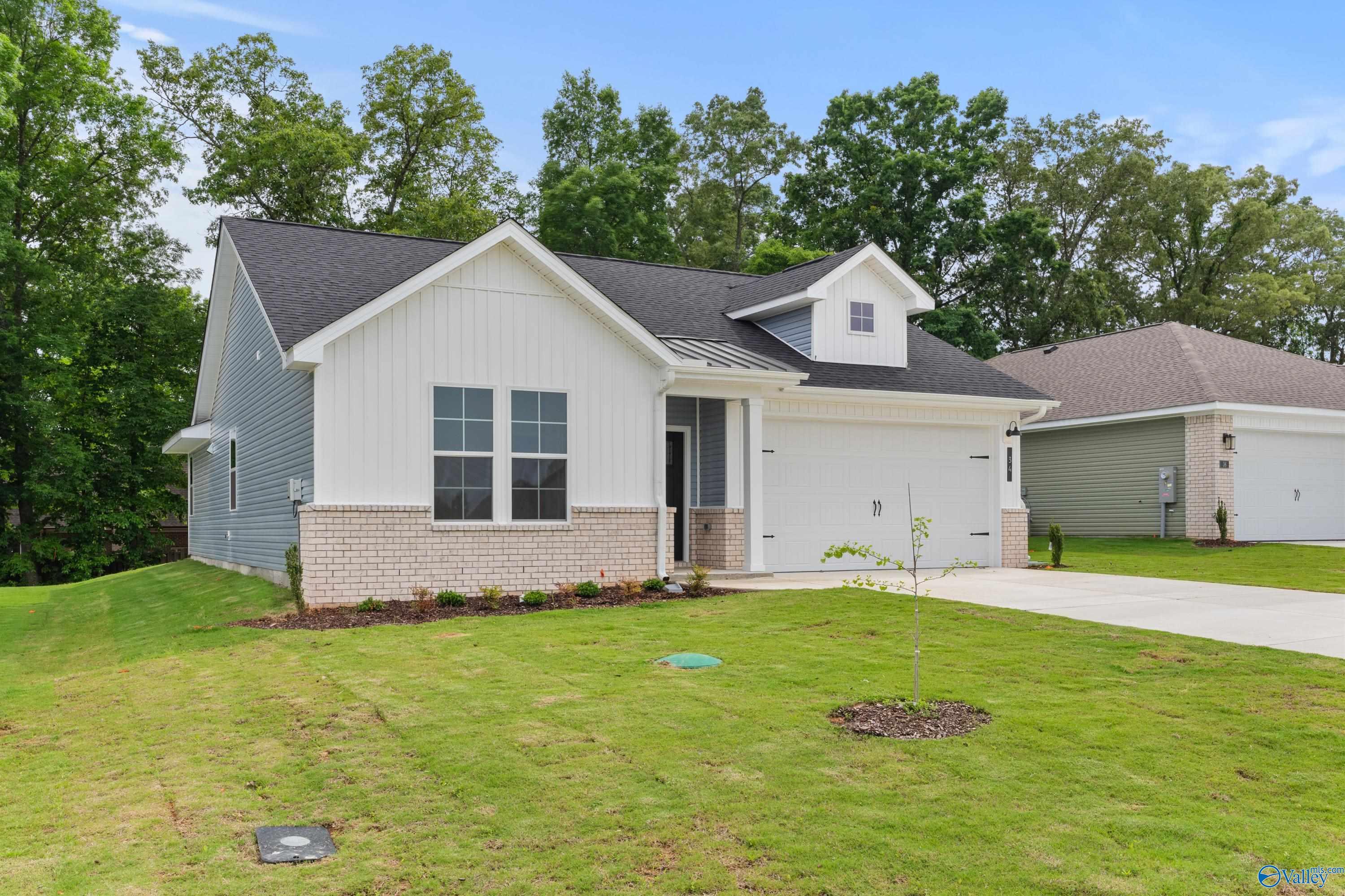Modern 1-story The Phoenix home with white shiplap siding, 2-car garage, and landscaped yard in Bailey Park, Fayetteville, Tennessee