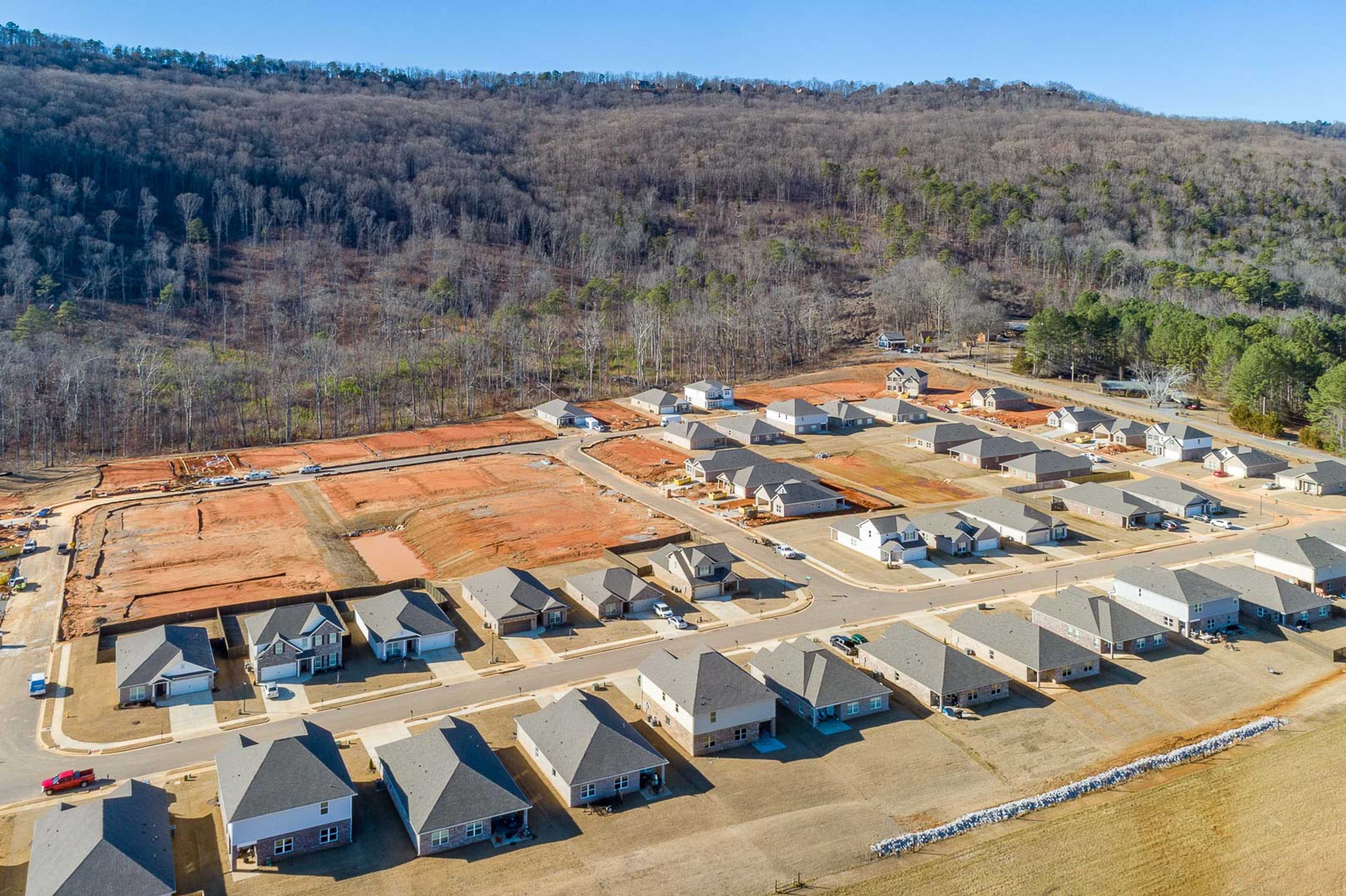 Aerial view of new homes under construction at Monteagle Cove in Owens Cross Roads Alabama amid wooded hills