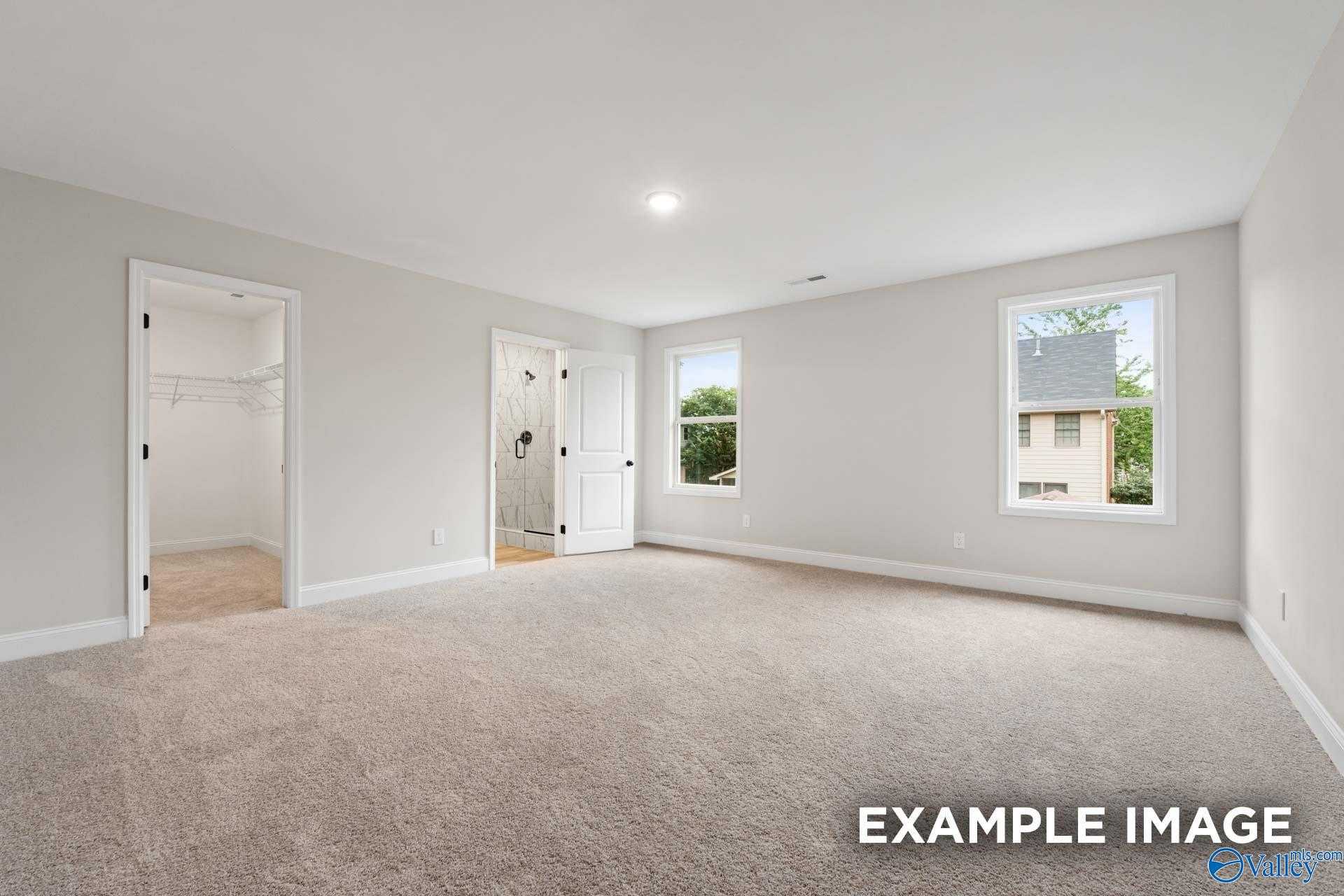 Spacious master bedroom with walk-in closet and en-suite bath in Davidson Homes The Camden D, Pavilion, Huntsville, AL