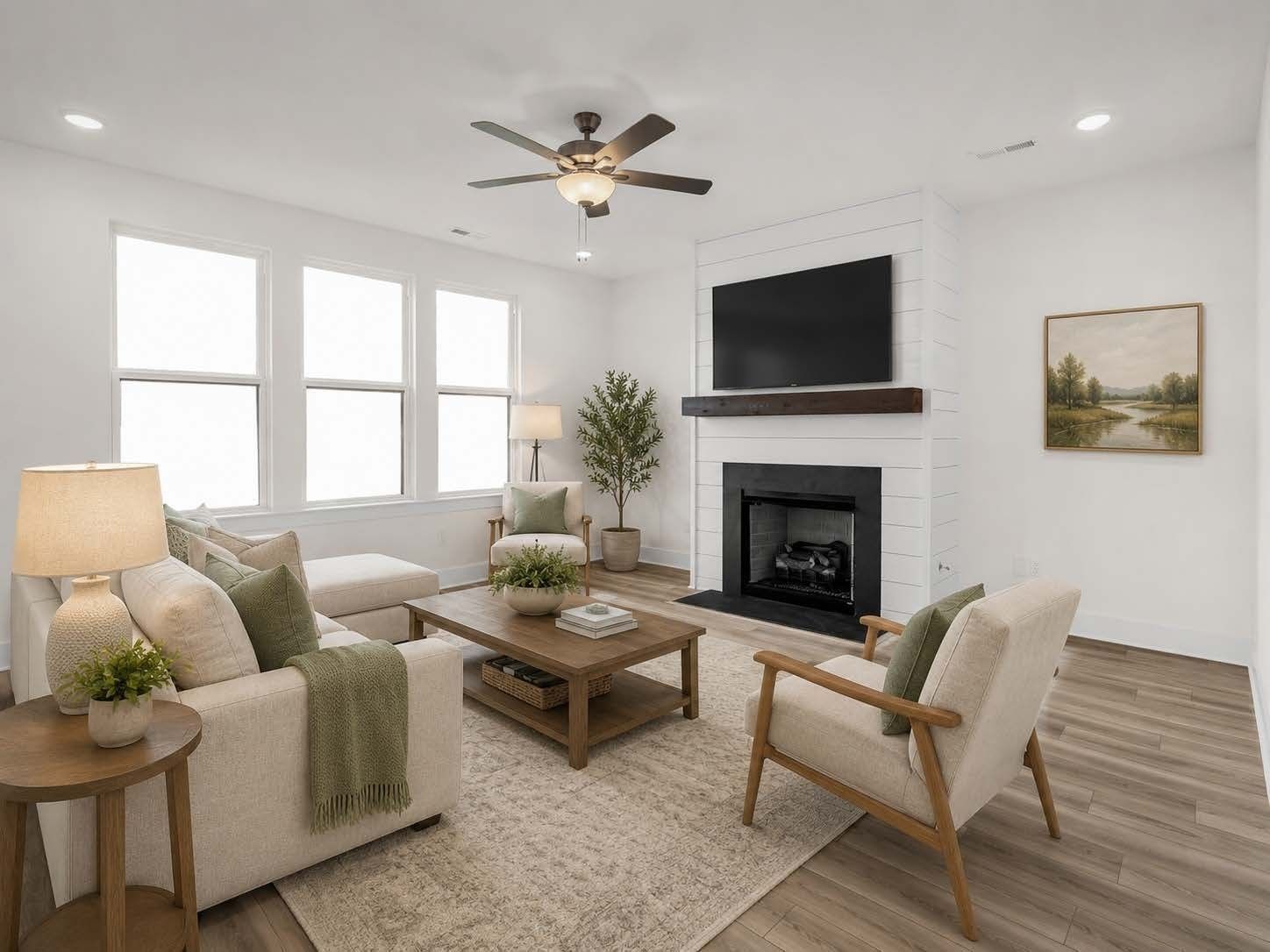 Bright living room with shiplap fireplace and natural decor in The Henry C floor plan by Davidson Homes in Mt. Juliet, TN.