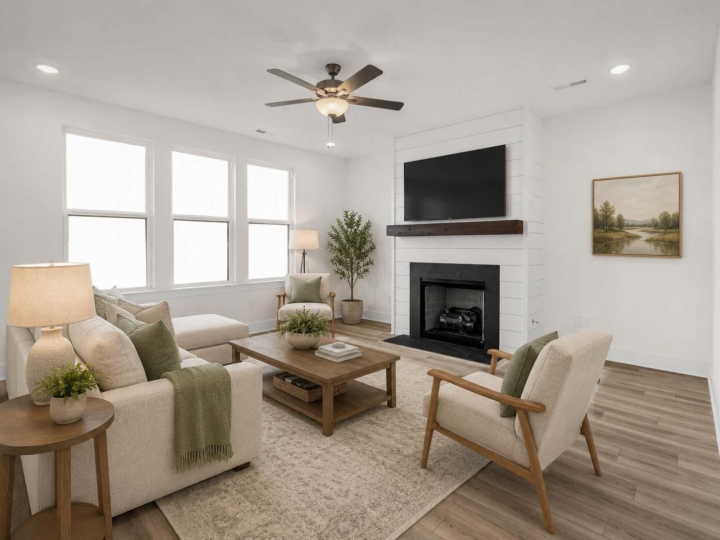 Bright living room with shiplap fireplace and natural decor in The Henry C floor plan by Davidson Homes in Mt. Juliet, TN.