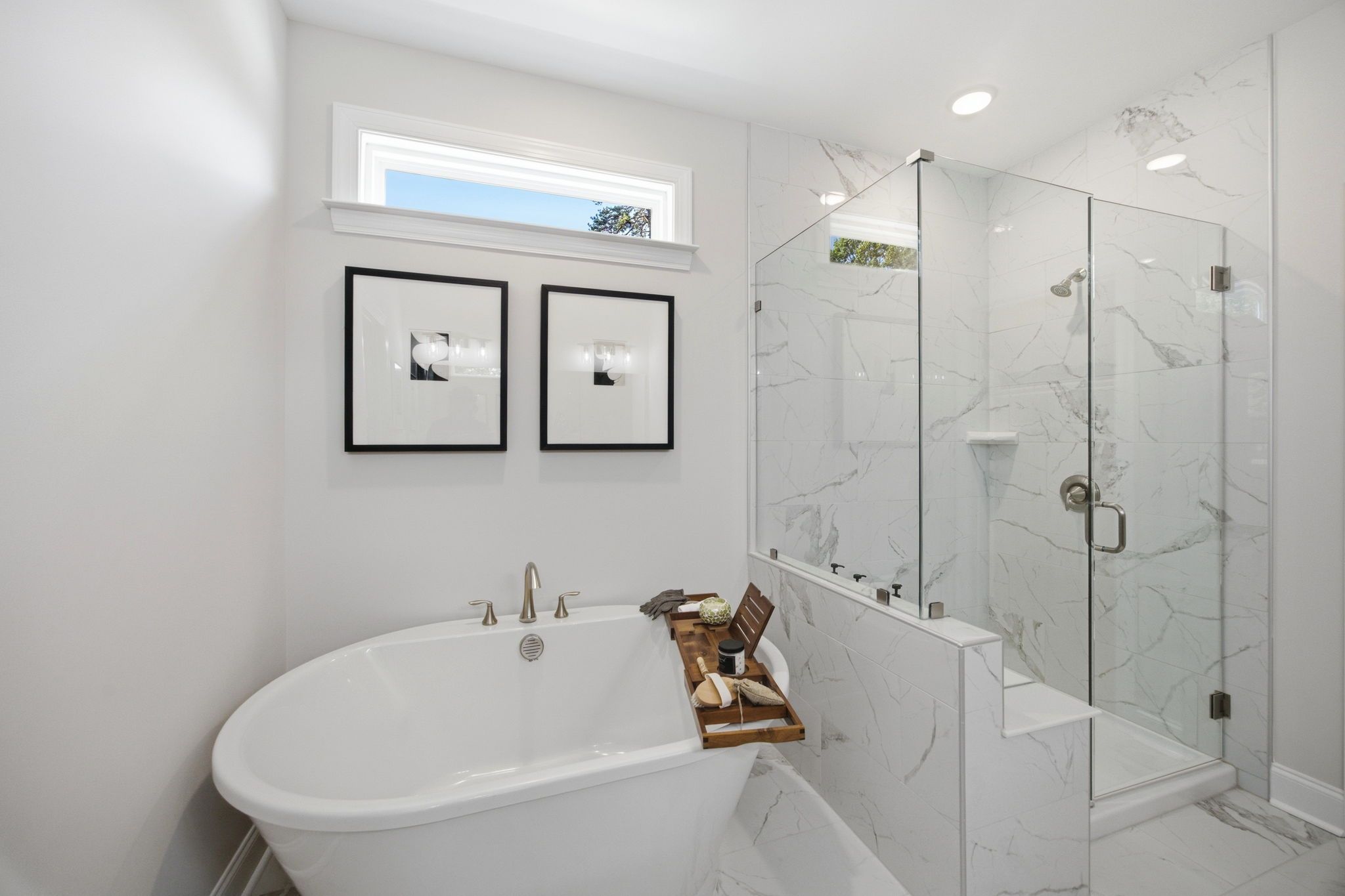 Luxury primary bathroom at Enclave at Belmont with a soaking tub and walk-in glass shower by Davidson Homes.