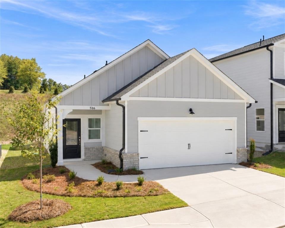Front exterior of The Oconee B by Davidson Homes — 3-bedroom, 2-car garage home in The Bluffs, Canton, Georgia.