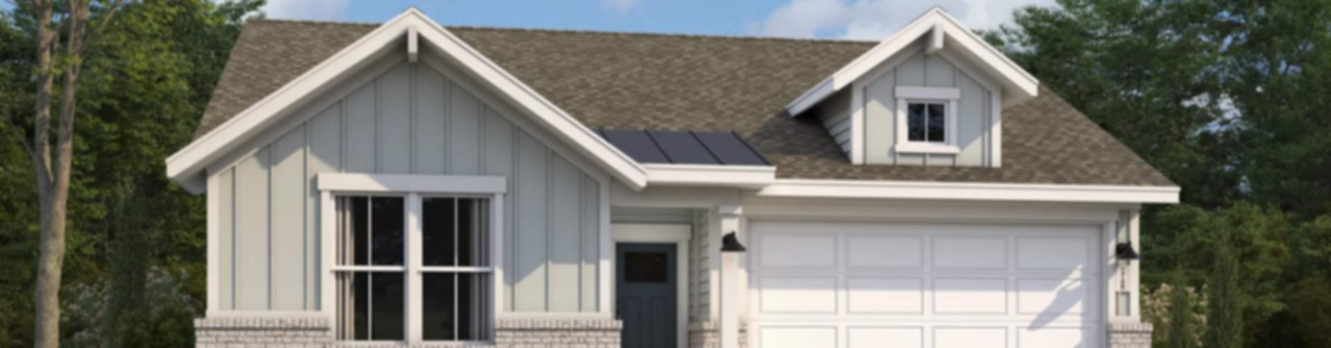 Modern gray Craftsman-style home with gabled roof, white garage, large windows, and lush landscaping in Opelika