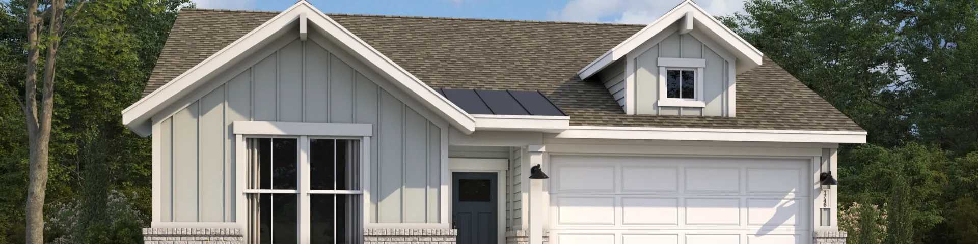 Modern gray Craftsman-style home with gabled roof, white garage, large windows, and lush landscaping in Opelika