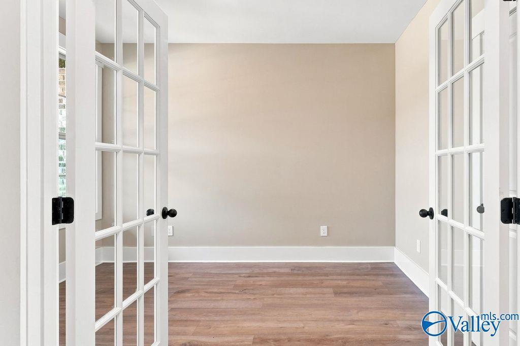 Bright home office or flex room with white French doors in The Rockford floor plan by Davidson Homes in Hartselle, Alabama.