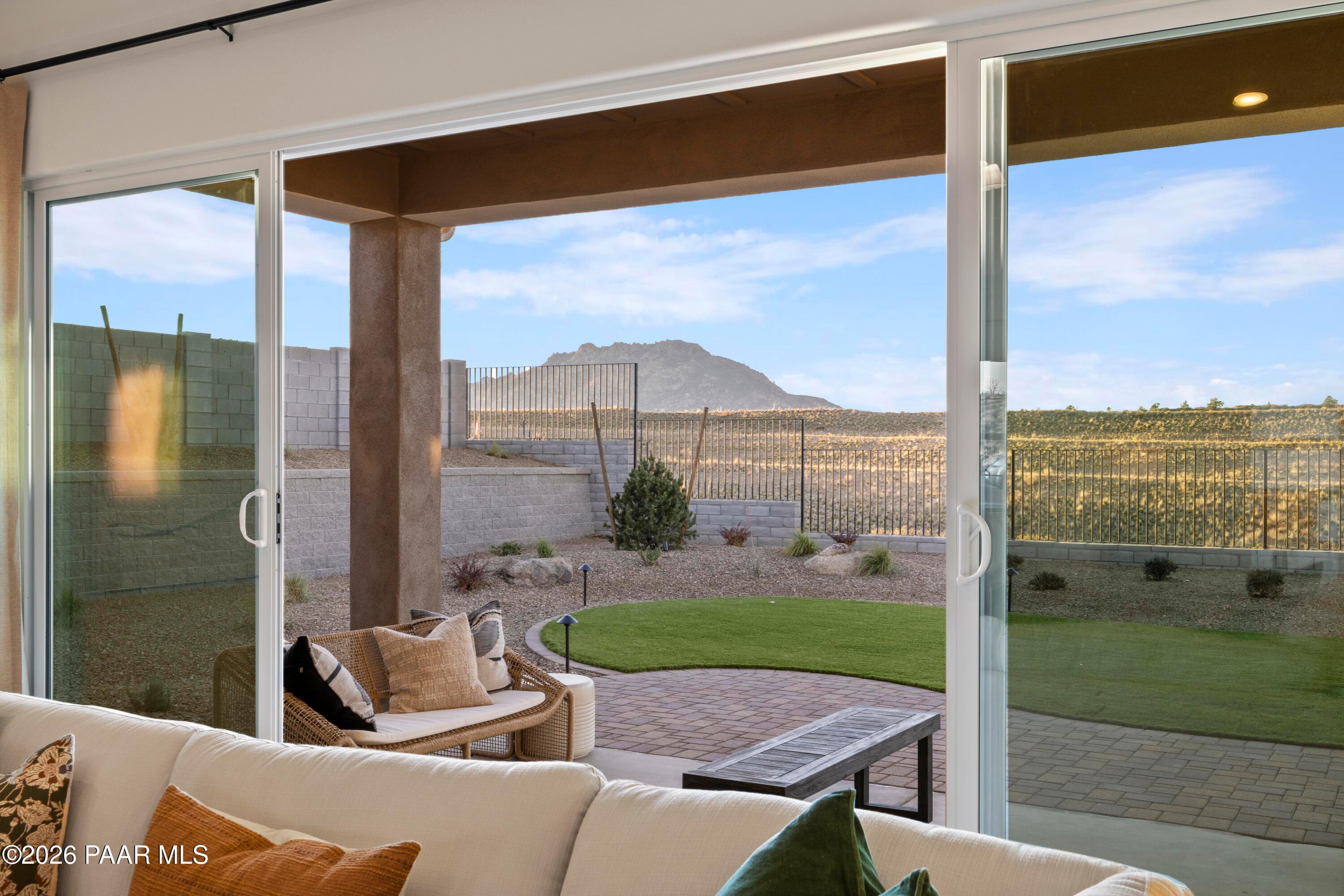 Sliding glass doors opening to a covered patio with mountain views in Hidden Hills, Prescott, Arizona by Davidson Homes.
