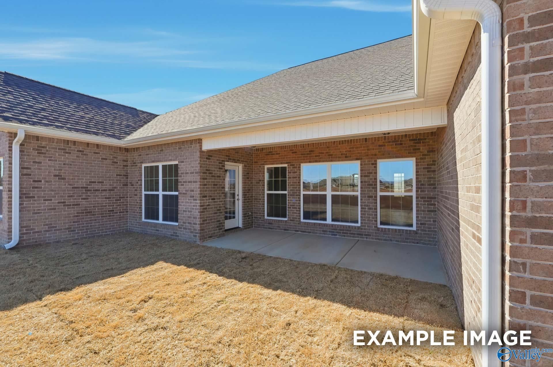 Covered concrete patio and brick exterior of The Valencia floor plan by Davidson Homes in Briercreek, Meridianville, Alabama.
