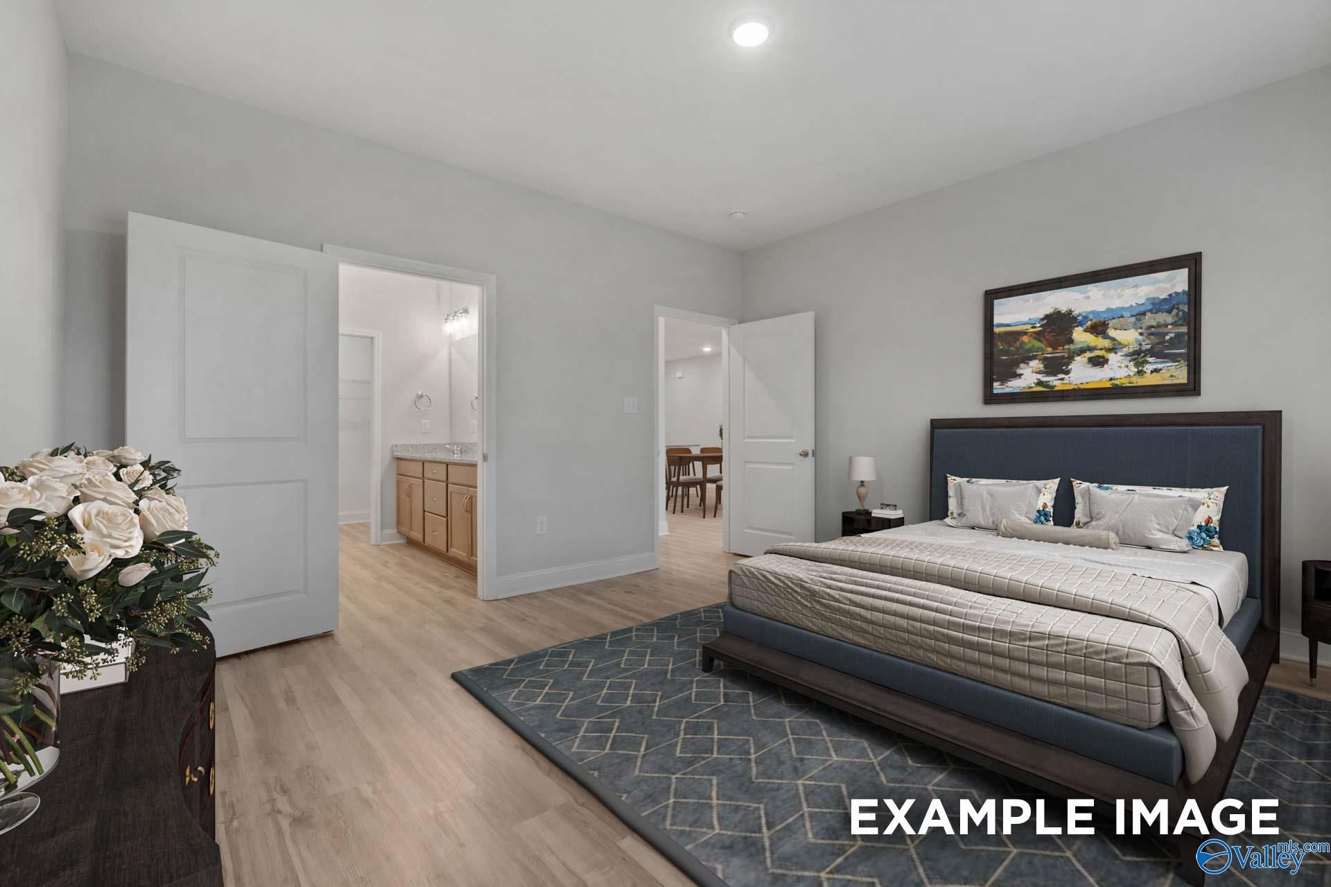 Serene gray master bedroom with en-suite bath, king bed, hardwood floors, and floral accents in Davidson Homes The Cumberland B, Decatur, AL
