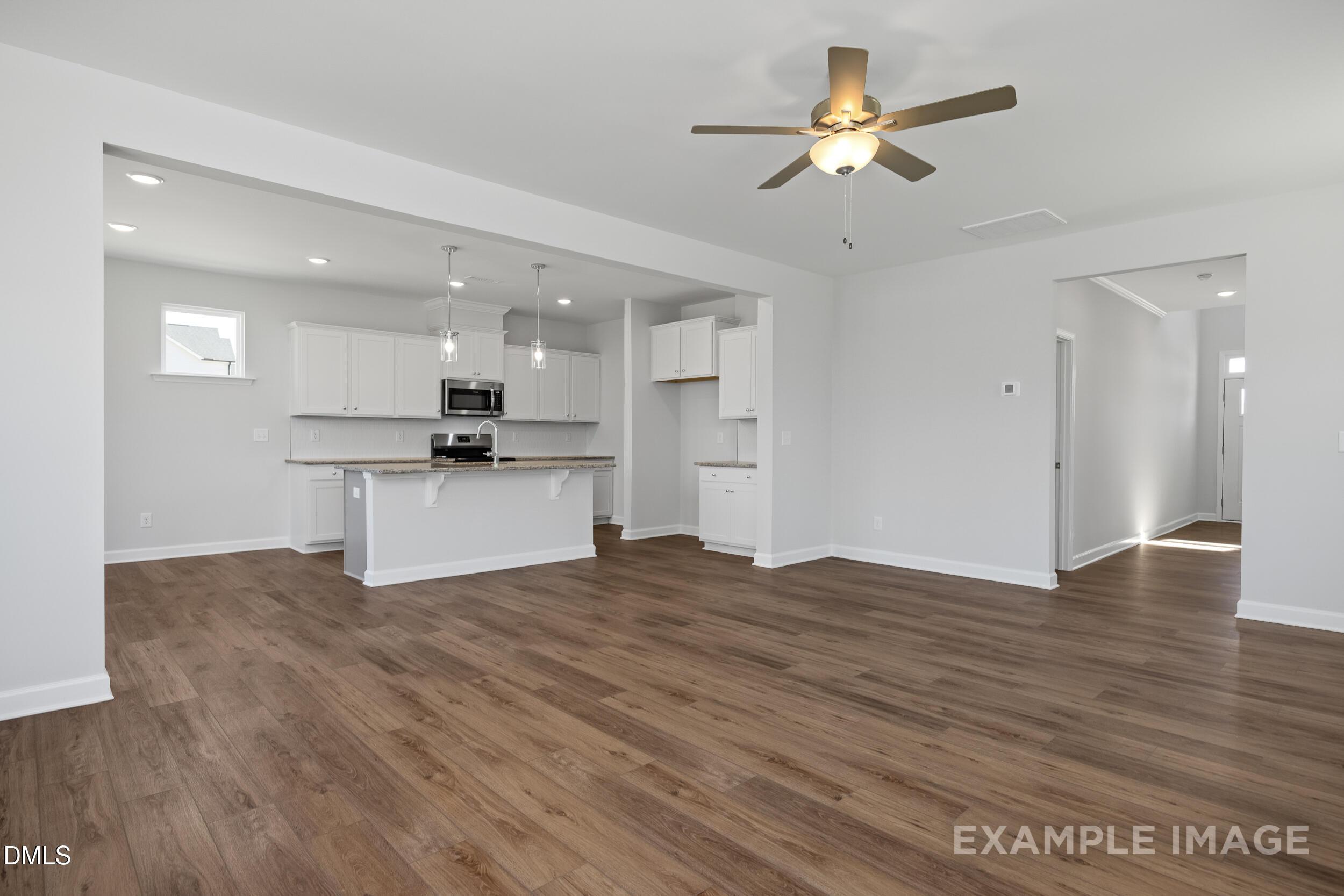 Open-concept living room and kitchen in The Gavin A floor plan by Davidson Homes in Gregory Village, Lillington, NC.