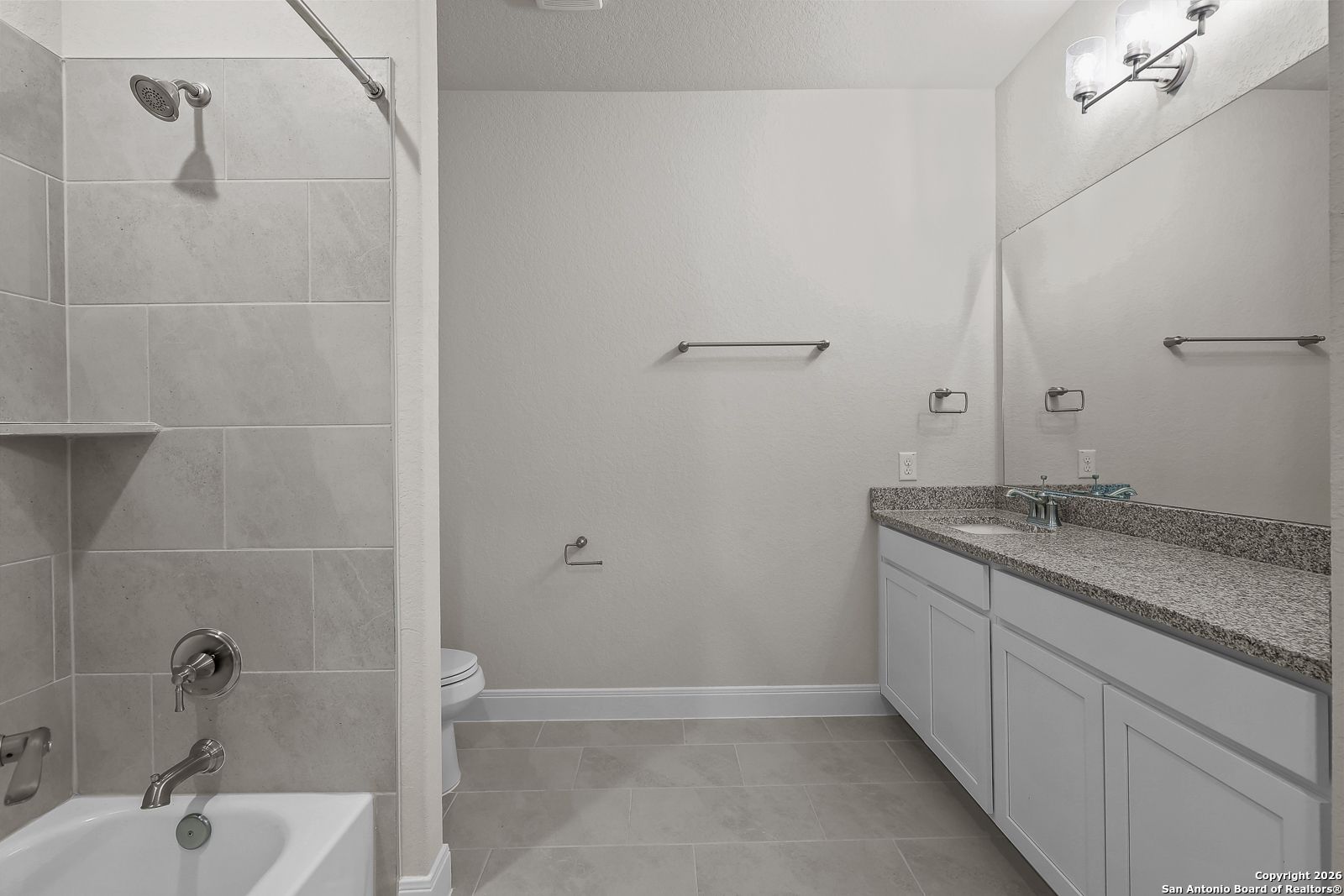 Elegant master bathroom with granite dual vanity, tiled walk-in shower, and soaking tub in Davidson Homes The Lanier H, Ladera San Antonio