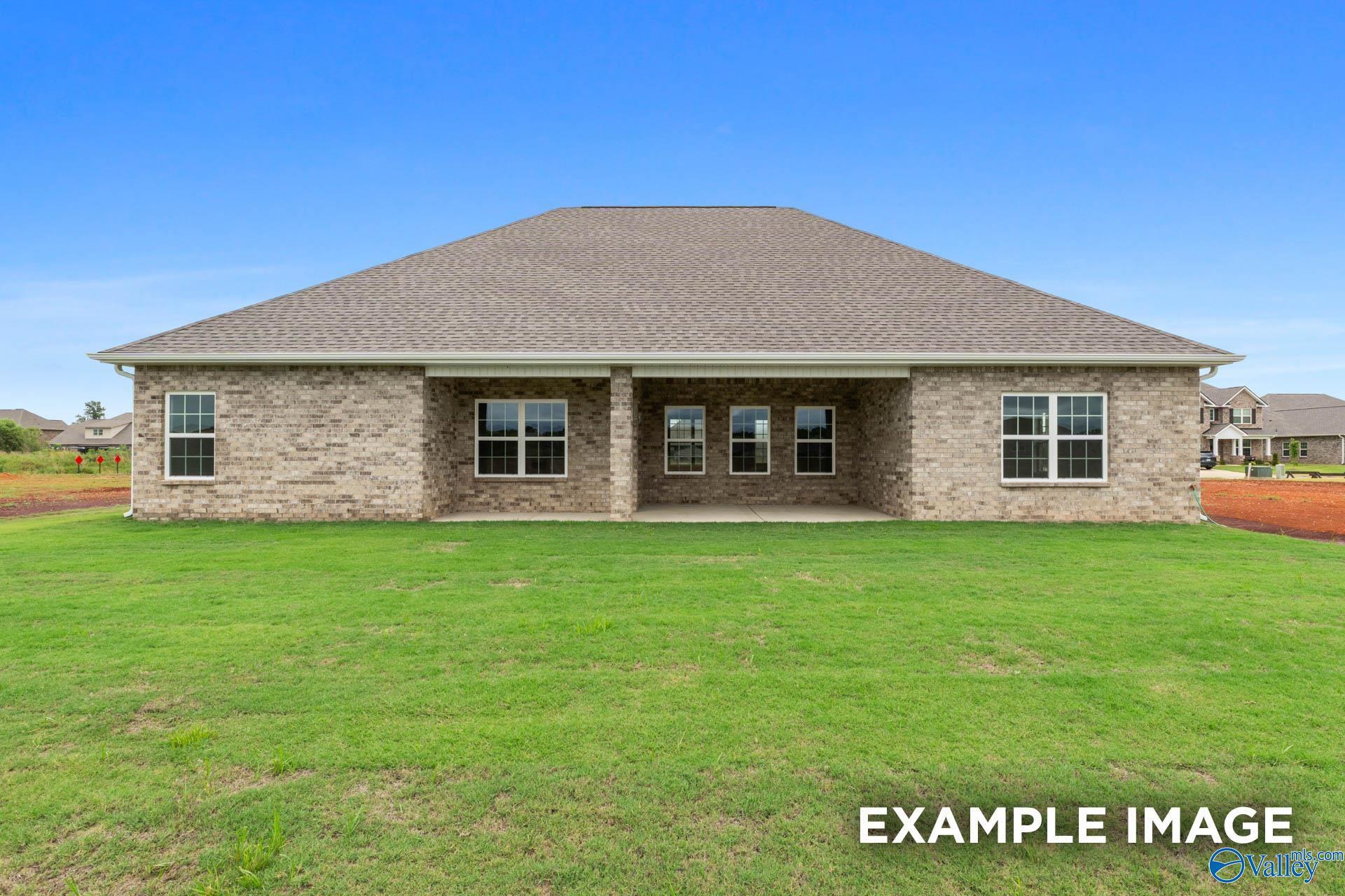 Rear view of brick 4-bedroom Oxford A home by Davidson Homes, covered patio, lush green lawn in Briercreek, Meridianville, AL