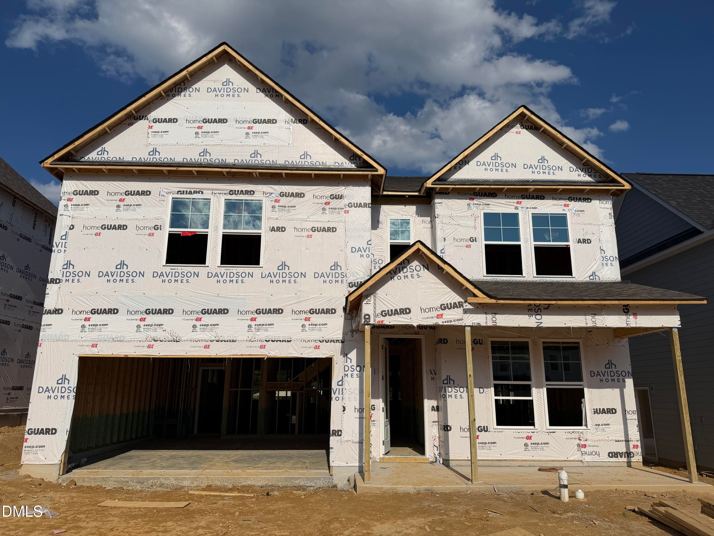 Two-story Davidson Homes The Beech floor plan under construction with covered front porch and 2-car garage in Wendell Ridge, NC