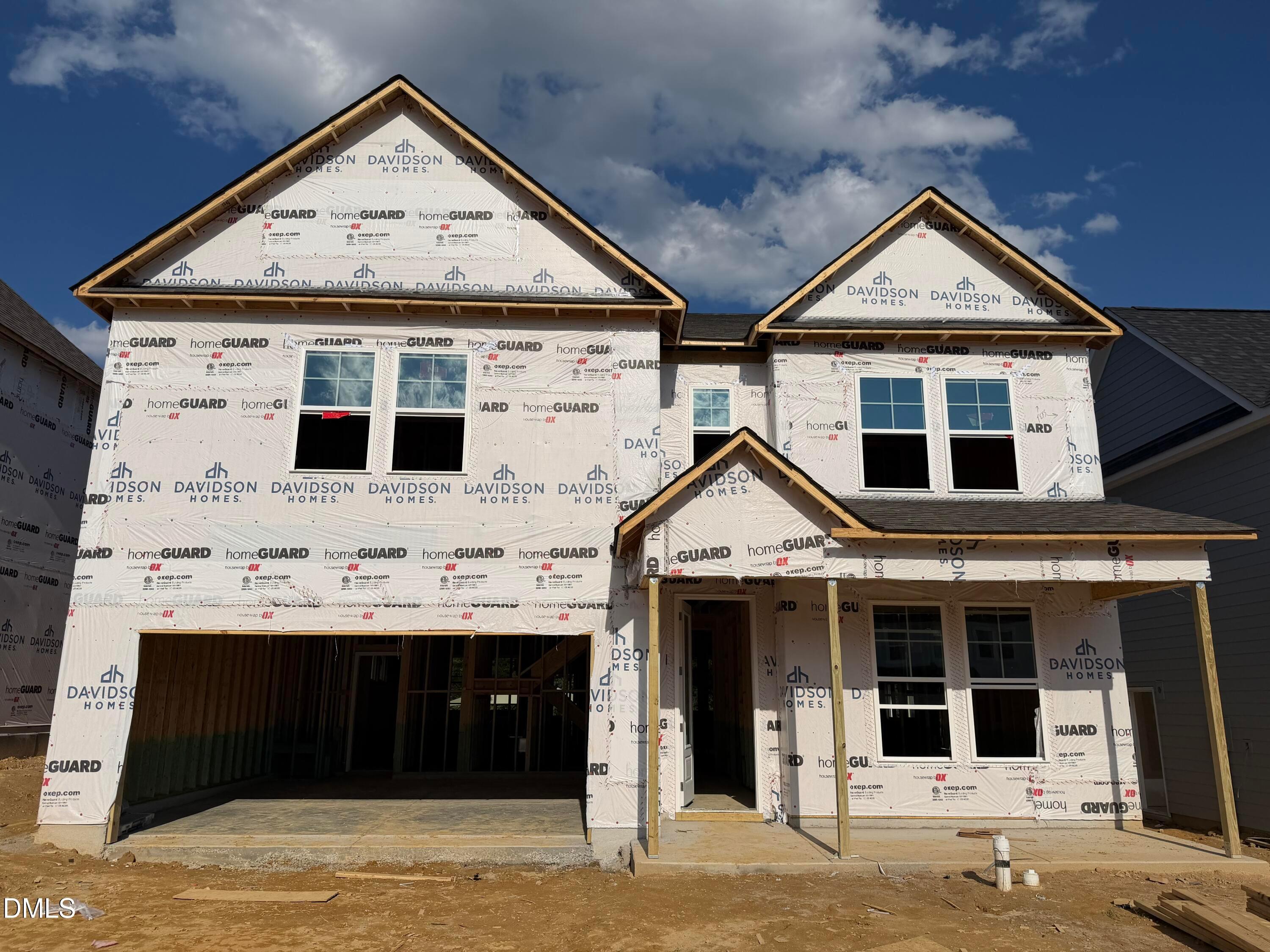 Two-story Davidson Homes The Beech floor plan under construction with covered front porch and 2-car garage in Wendell Ridge, NC
