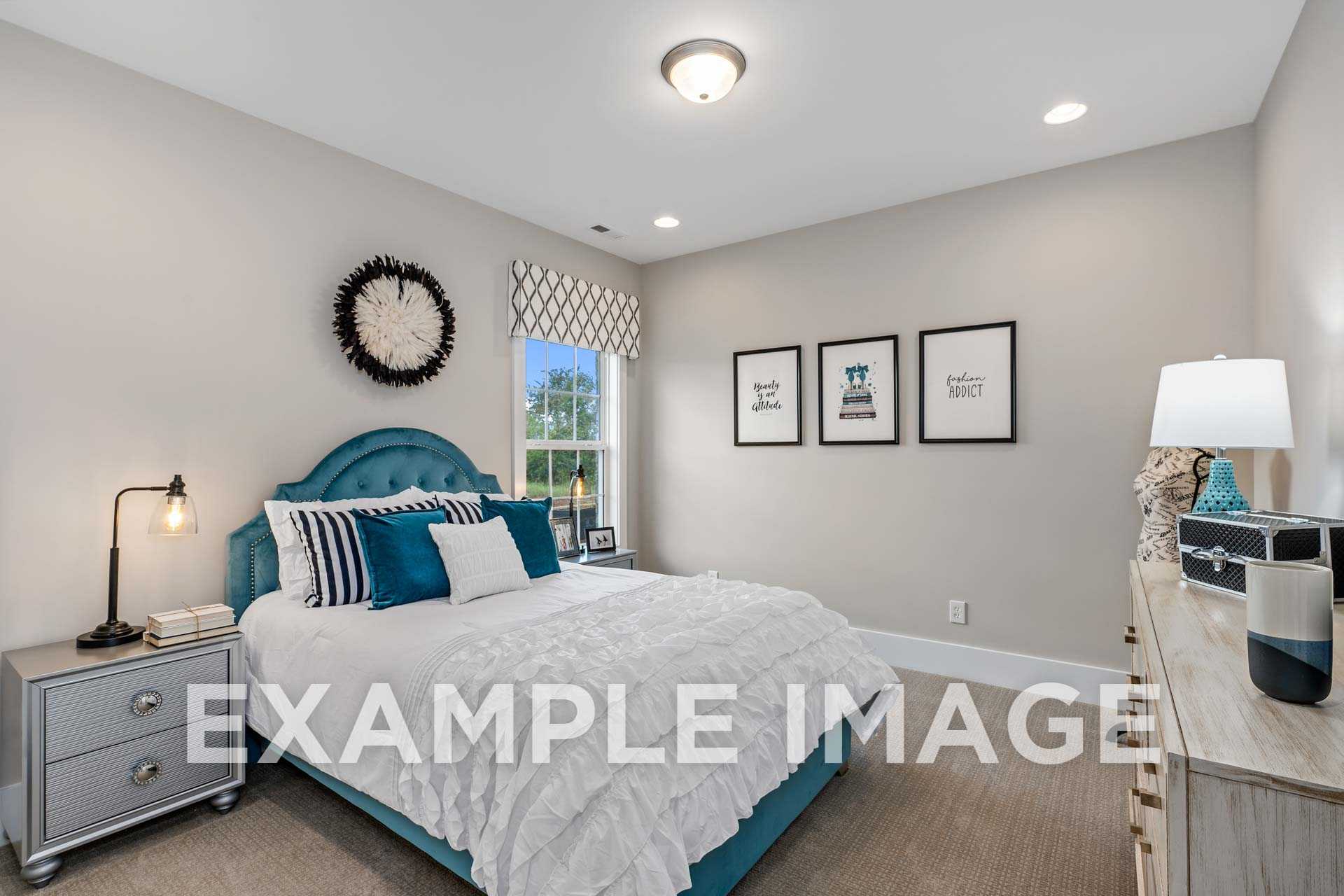 Cozy bedroom in The Harrison home with turquoise tufted headboard, white bedding, beige walls, and window curtains