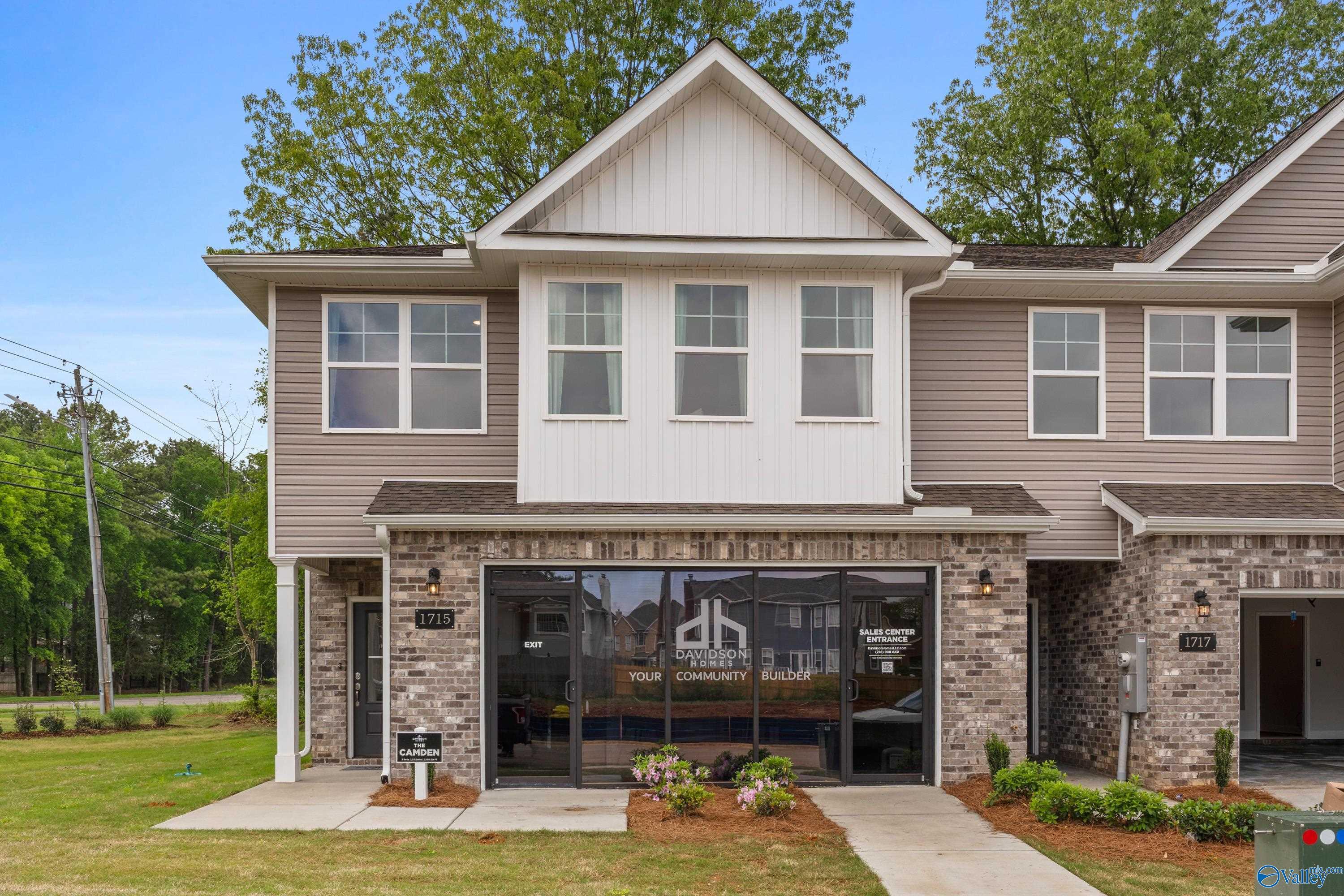 Modern two-story beige home with brick garage and Davidson Homes sign in Pavilion, Huntsville, Alabama