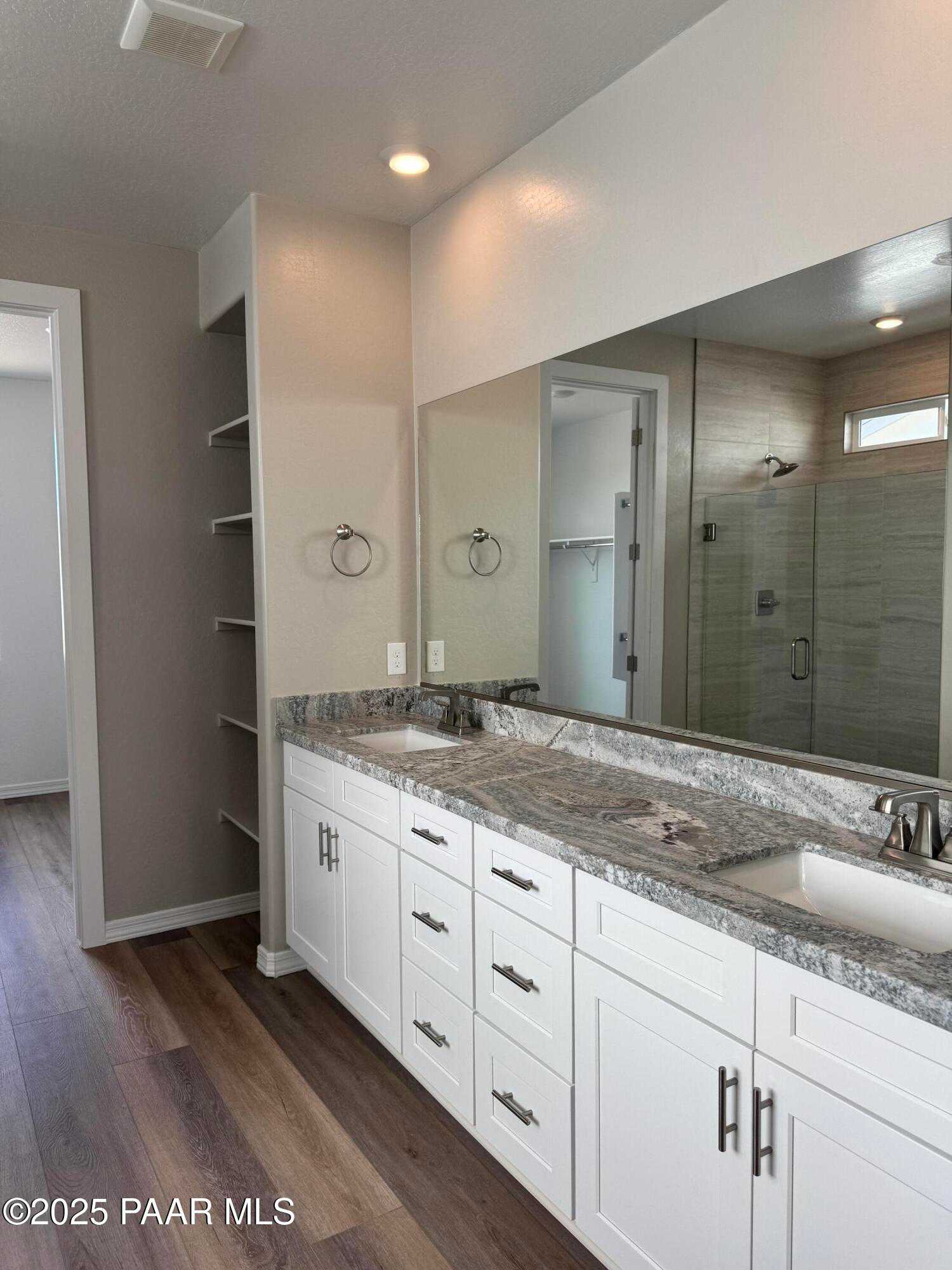 Modern master bathroom featuring double vanity with quartz counters, white cabinets, glass shower in Davidson Homes The Monarch A, Prescott AZ