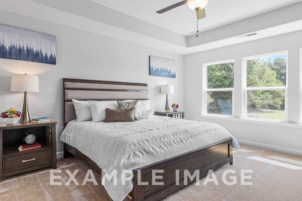 Davidson Homes The Chestnut Plan Master Bedroom with Bed and Nightstands decorated with lamps, decor, and wall art