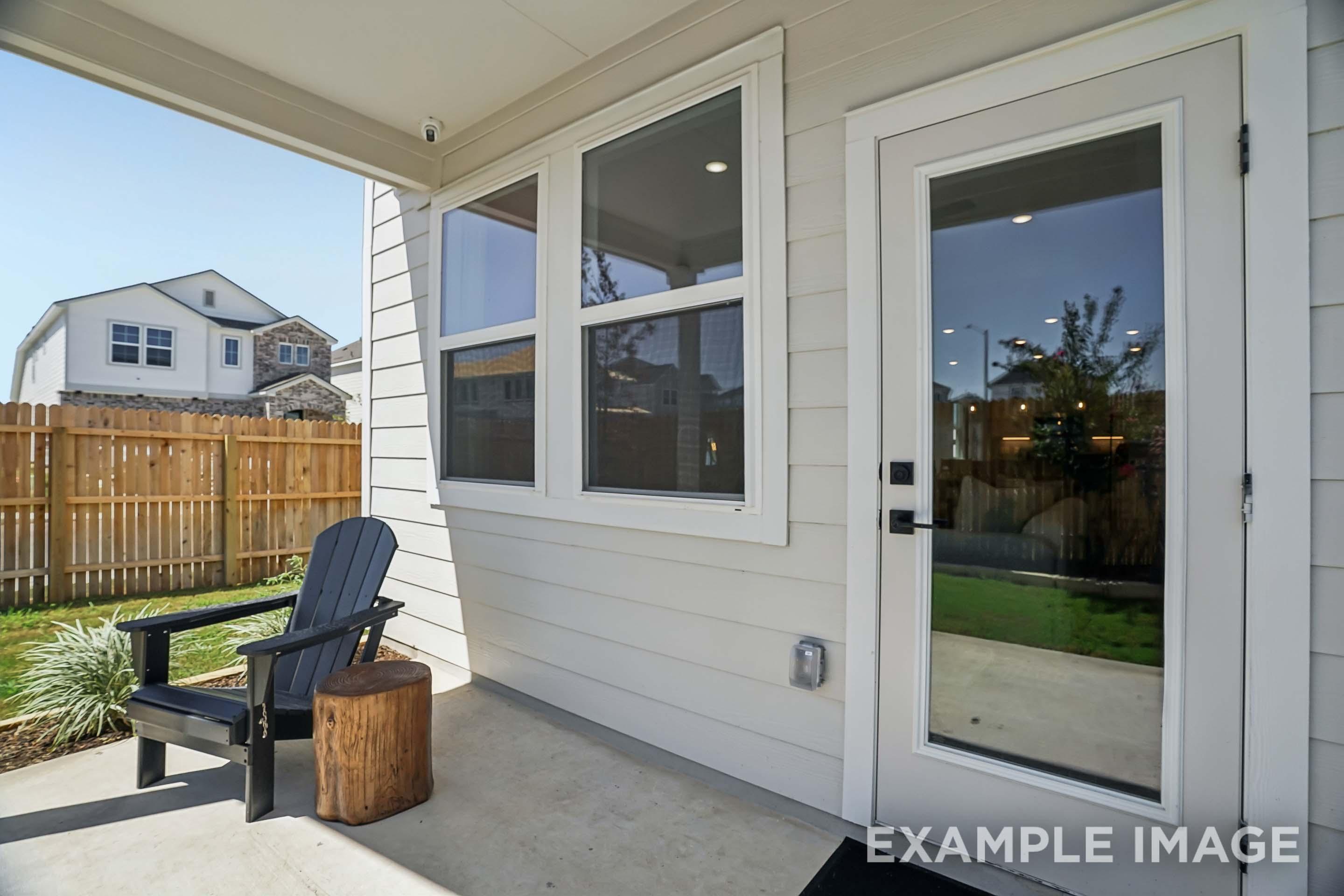 Covered patio of The Pinecrest D home in San Antonio featuring concrete flooring, siding exterior, and access door.