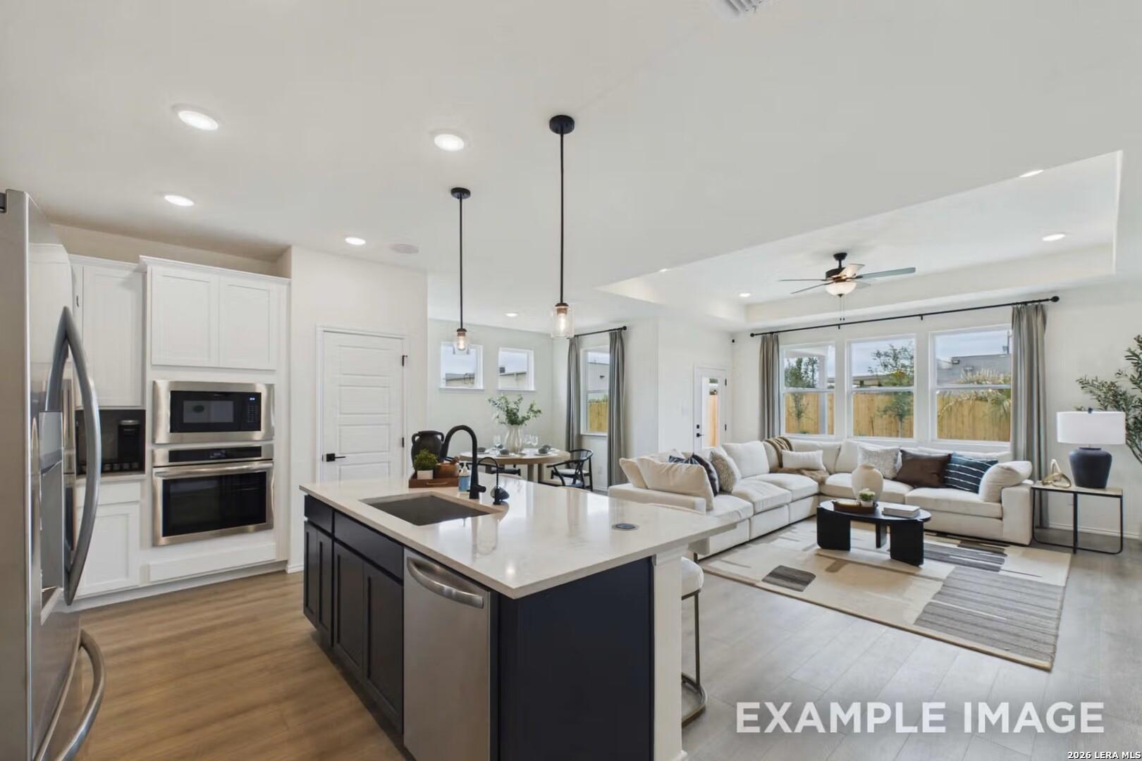 Open-concept kitchen and living area in The Laurel I floor plan by Davidson Homes in Rayburn Valley, San Antonio, Texas.