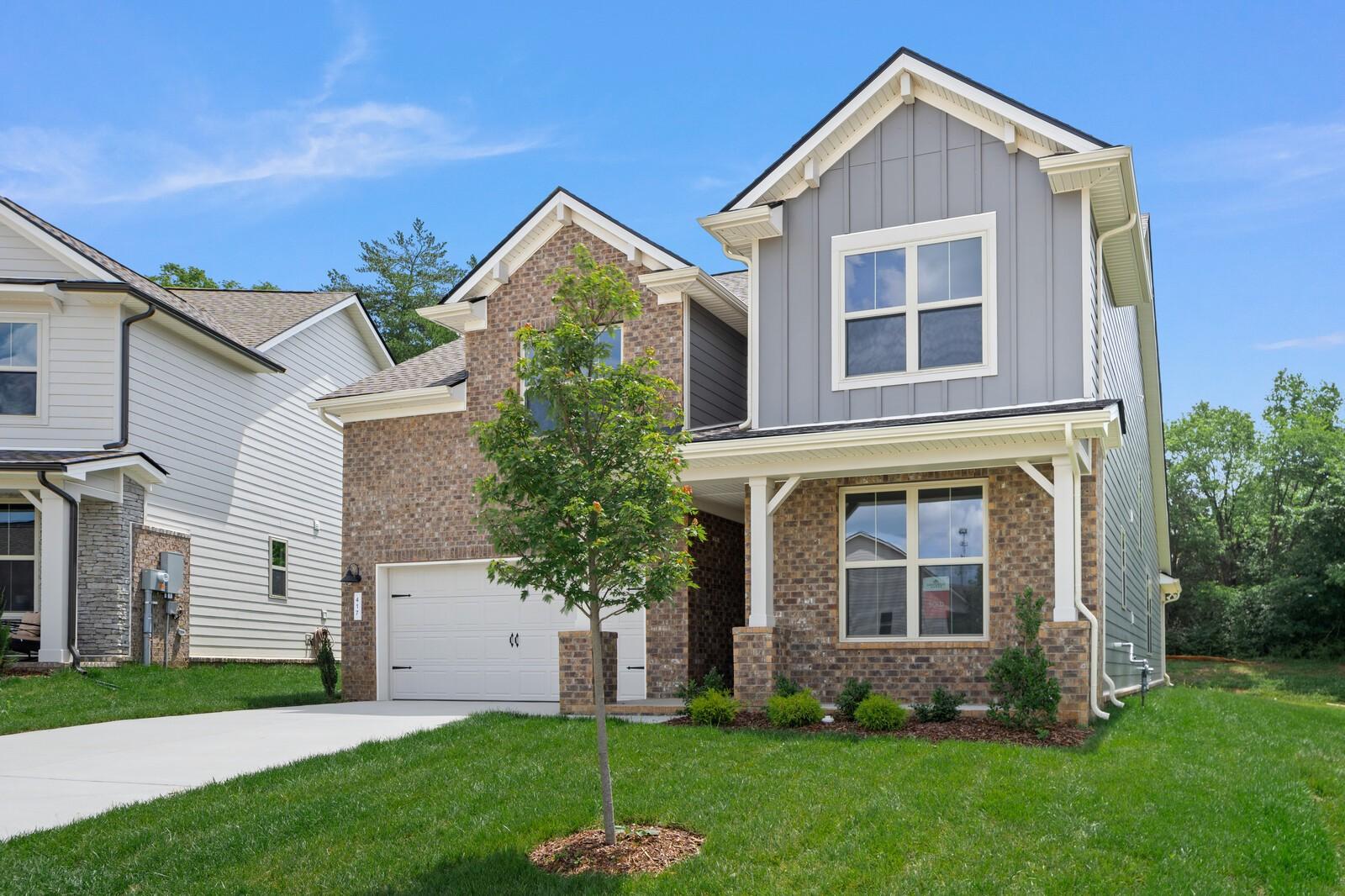 Two-story Ridgeport C home by Davidson Homes with brick and siding exterior in Woods Crossing, Gallatin, Tennessee.