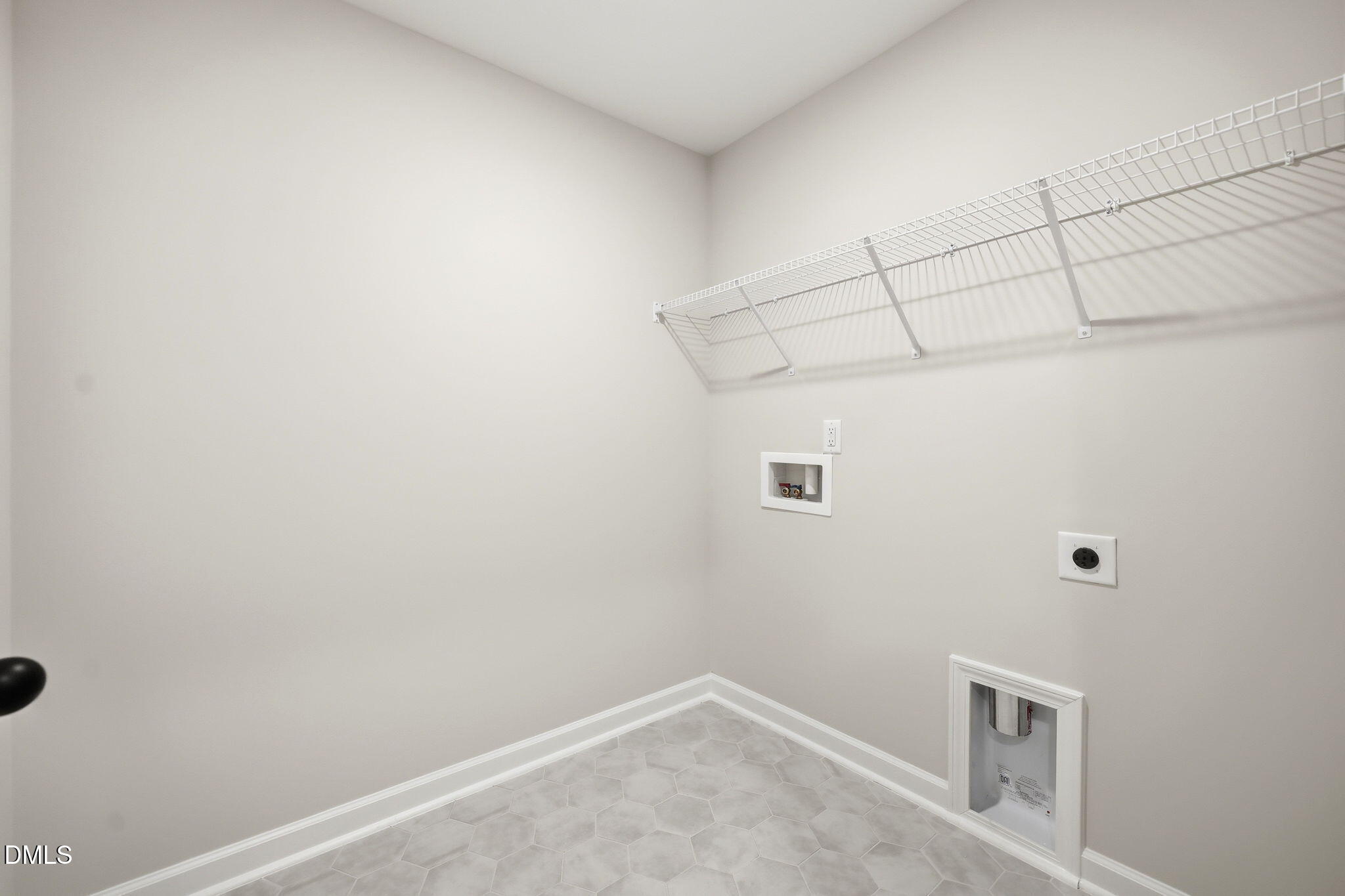 Laundry room with wire shelving and tile flooring in The Mitchell Interior floor plan at Camden Park, Knightdale, NC.