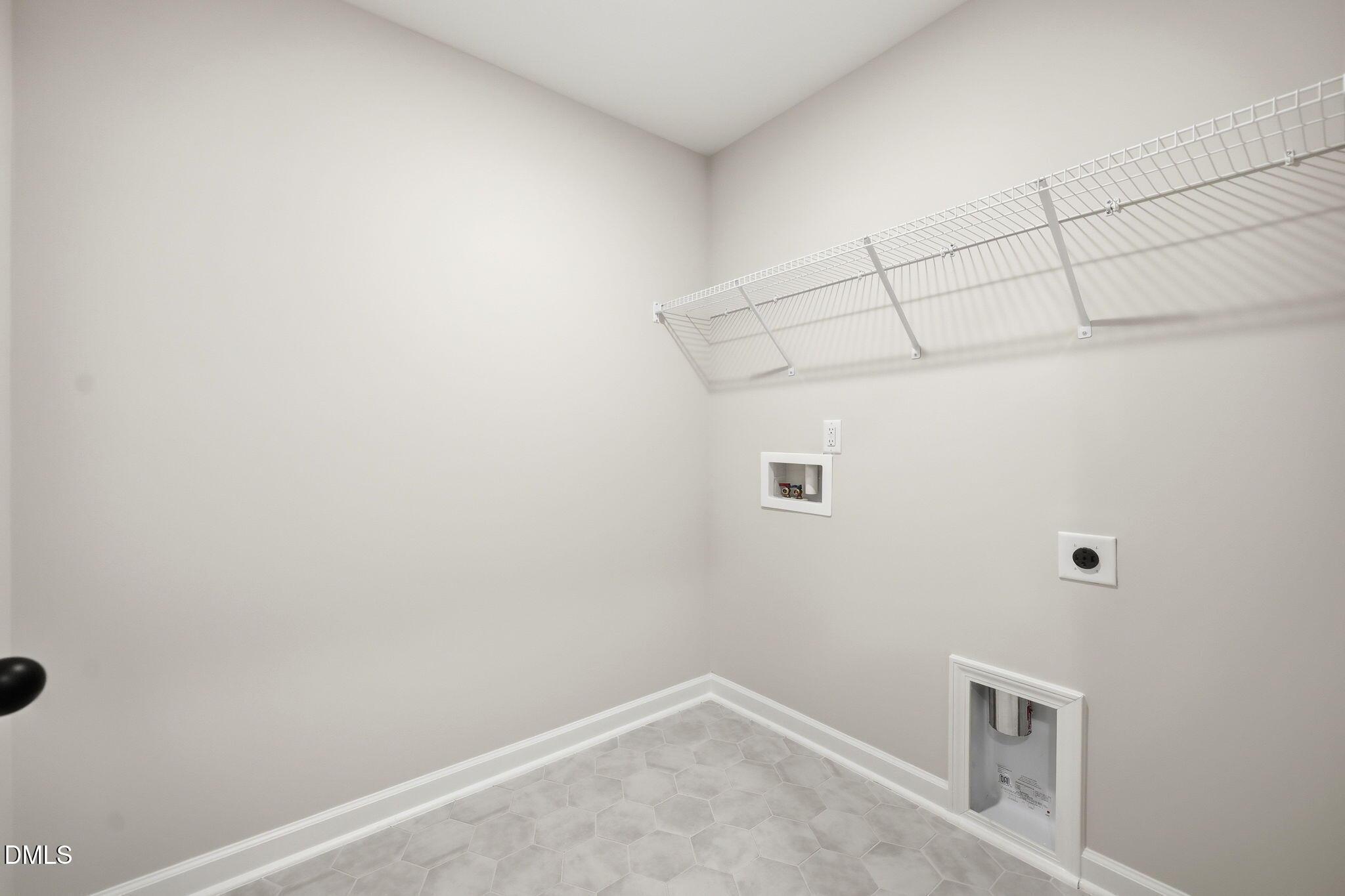 Laundry room with wire shelving and tile flooring in The Mitchell Interior floor plan at Camden Park, Knightdale, NC.