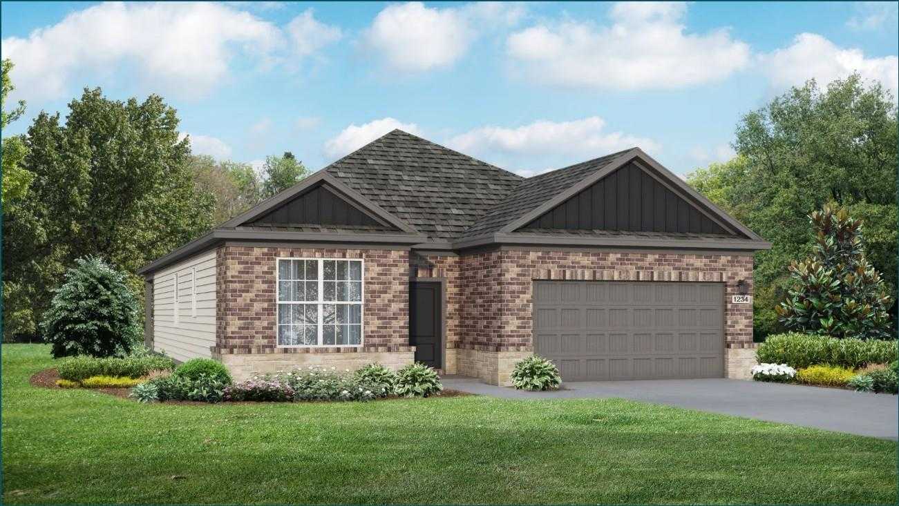 Modern single-story brick home with 2-car garage, gabled roof, and lush landscaping in Sundance Cove, Crosby, Texas by Davidson Homes