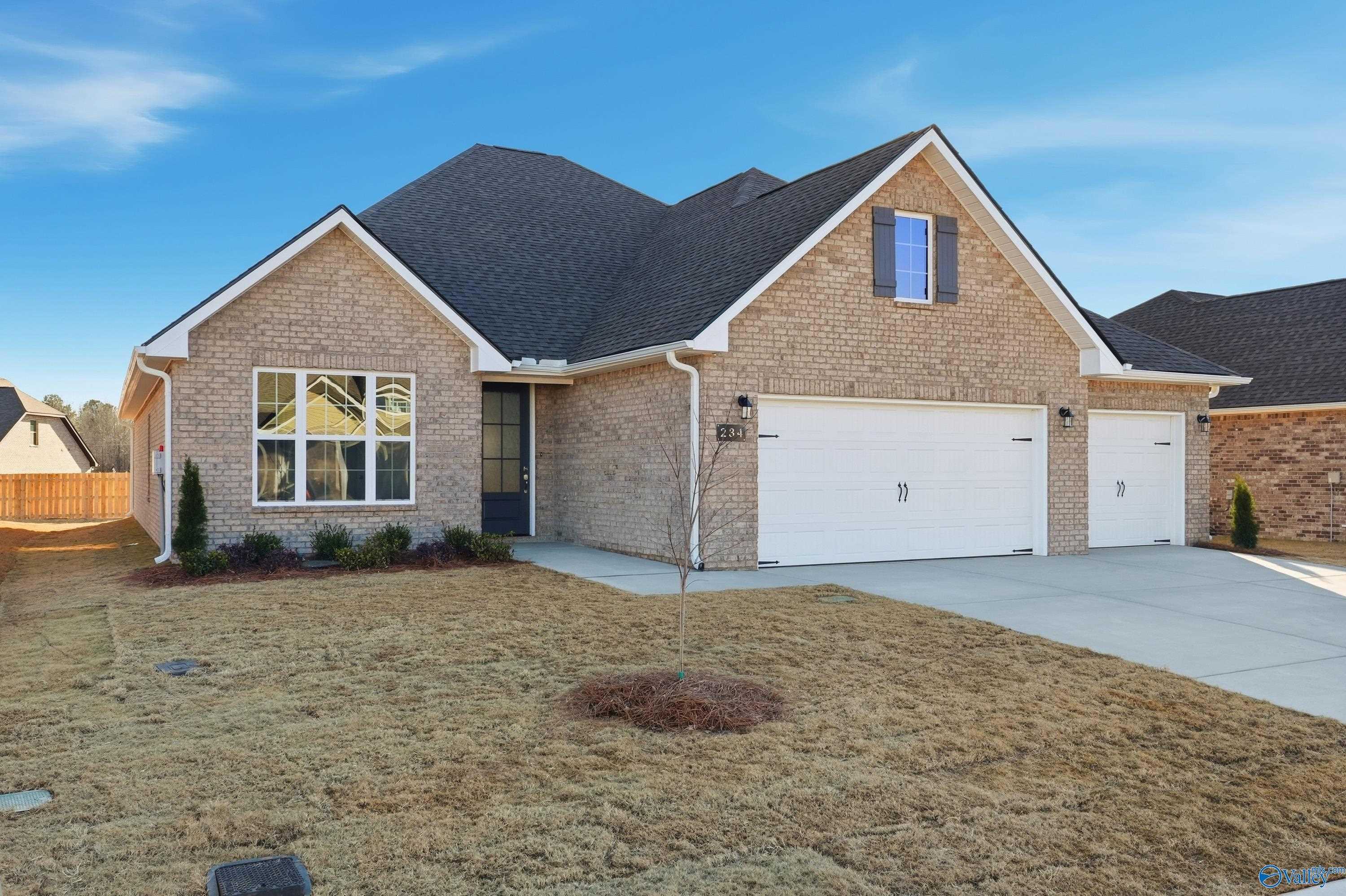1-story brick home with 2-car garage, gabled roof, and front yard landscaping in Kendall Downs, Toney, Alabama - Davidson Homes The Lanier