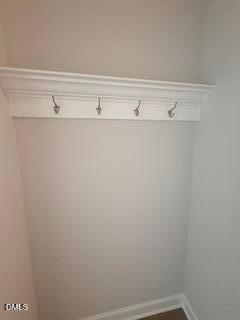 White wall-mounted coat rack with crown molding shelf in The Daphne D floor plan at Woodland Crossing in Zebulon, NC.