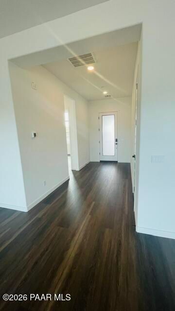 Bright entryway with wood-style flooring and modern glass-panel door in The Aurea C home at Hidden Hills, Prescott, AZ.