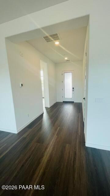Bright entryway with wood-style flooring and modern glass-panel door in The Aurea C home at Hidden Hills, Prescott, AZ.