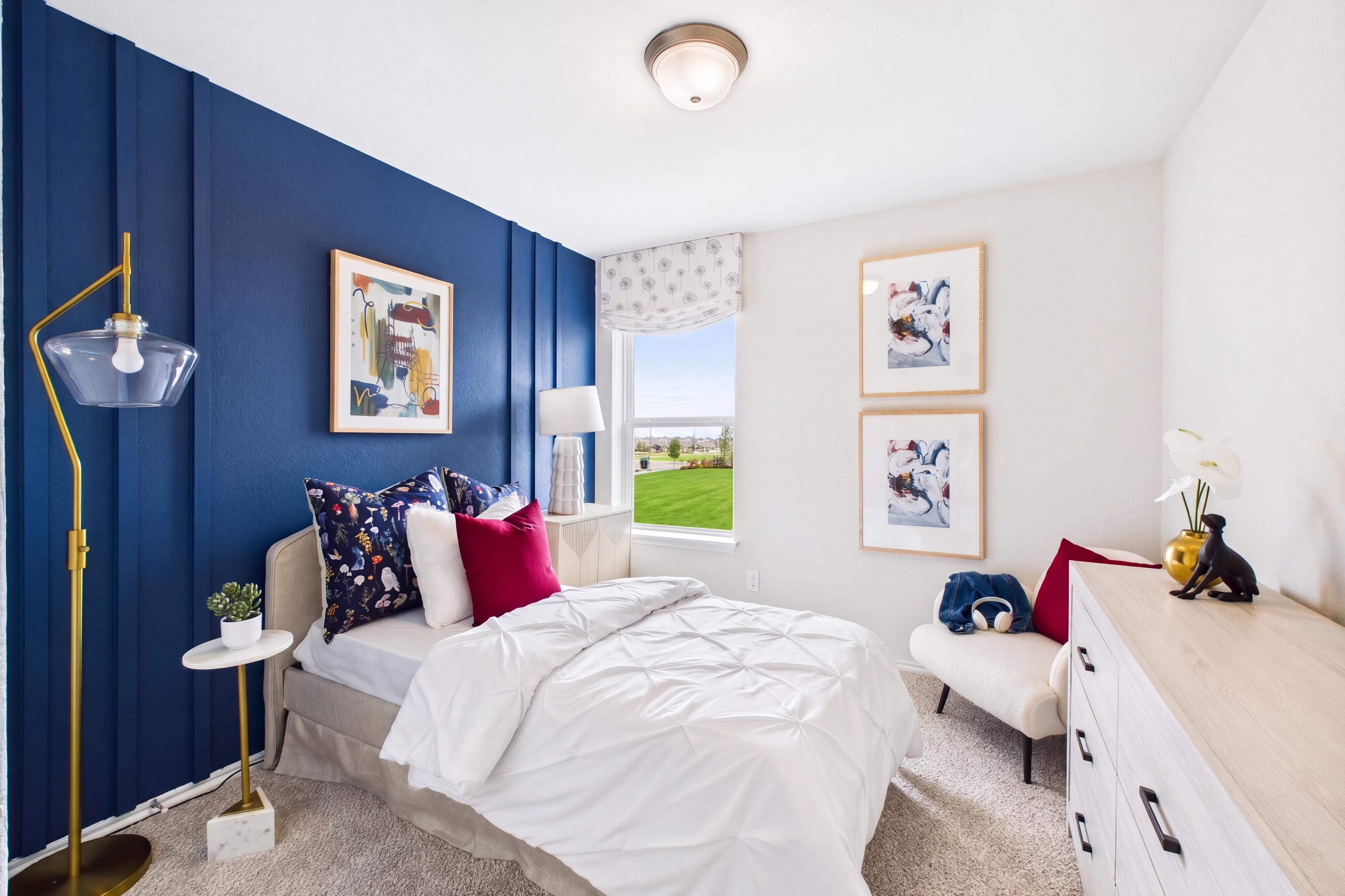 Decorated bedroom with trim accent wall and window, located in San Antonio, TX