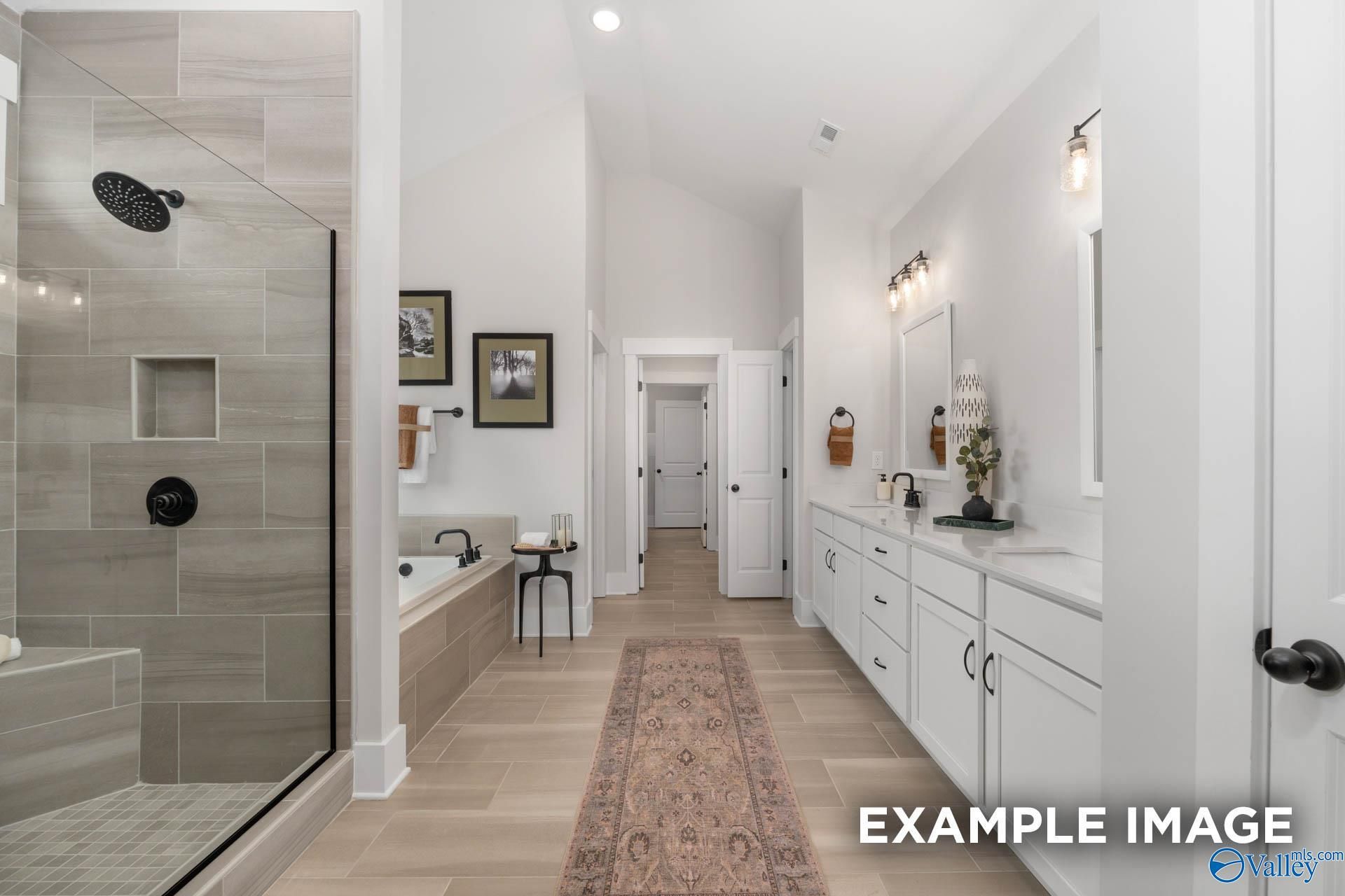 Luxurious master bathroom featuring walk-in shower, freestanding tub, and double vanity in The Finleigh by Davidson Homes, Decatur, AL