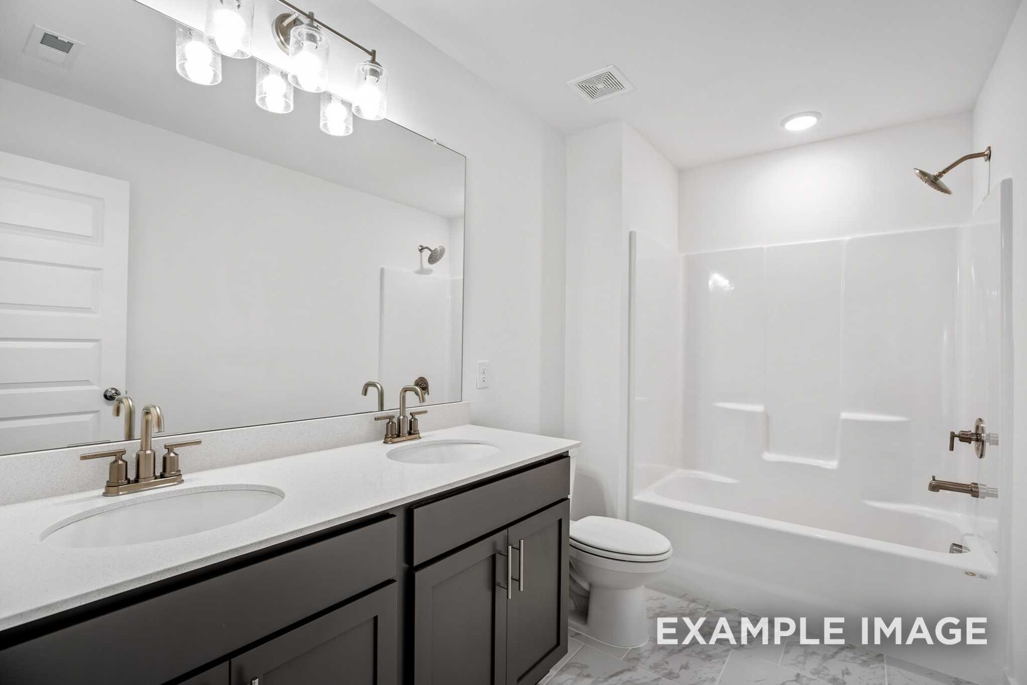 Spacious master bathroom in The Murray B with double vanity, soaking tub, and walk-in shower