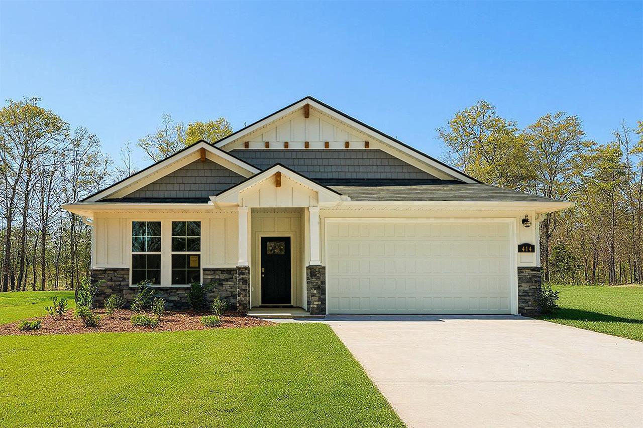 Modern farmhouse home exterior in Heatherbrook, Phenix City AL with gabled roof, stone accents, covered porch and garage