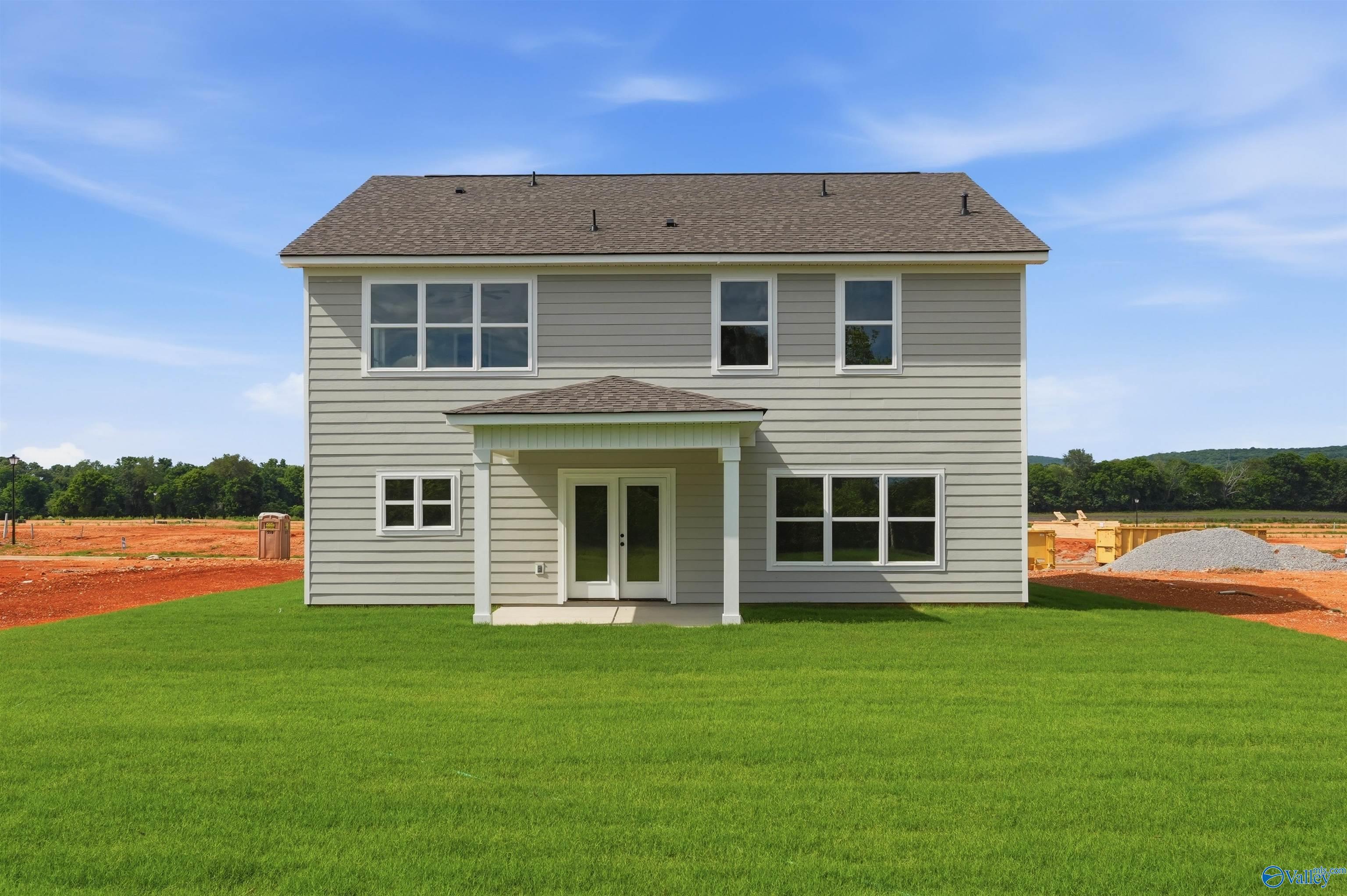 Rear view of a 2-story Chelsea D floor plan by Davidson Homes with a covered patio in Berry Cove, New Market, Alabama.