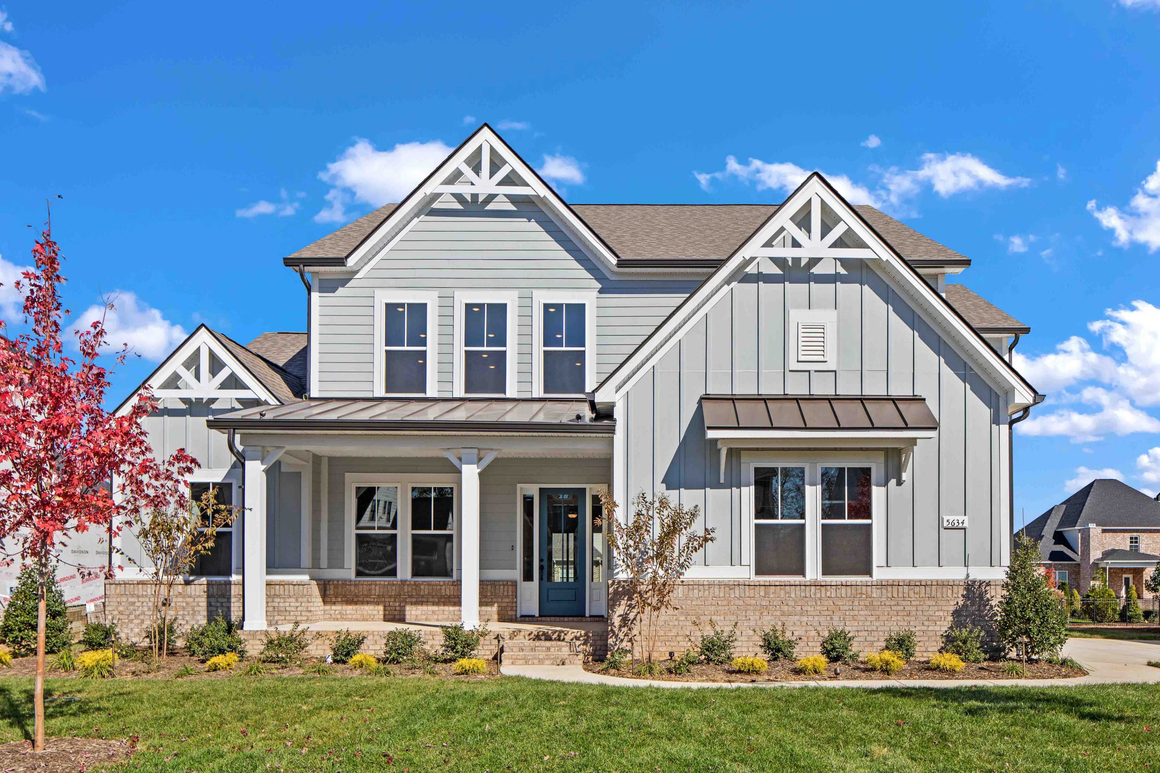 Modern farmhouse home exterior at Shelton Square in Murfreesboro TN with covered porch, gabled roof, and landscaping