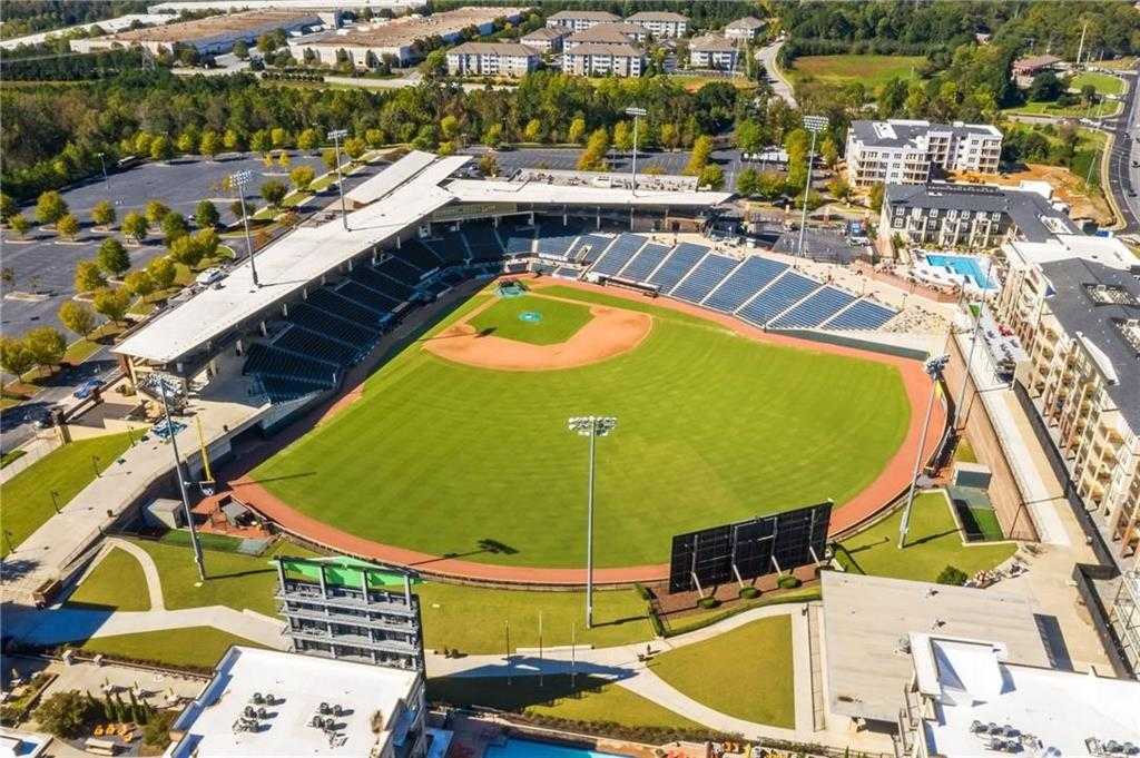 Aerial view of baseball stadium with green diamond field, bleachers, and surrounding apartments in Buford, Georgia