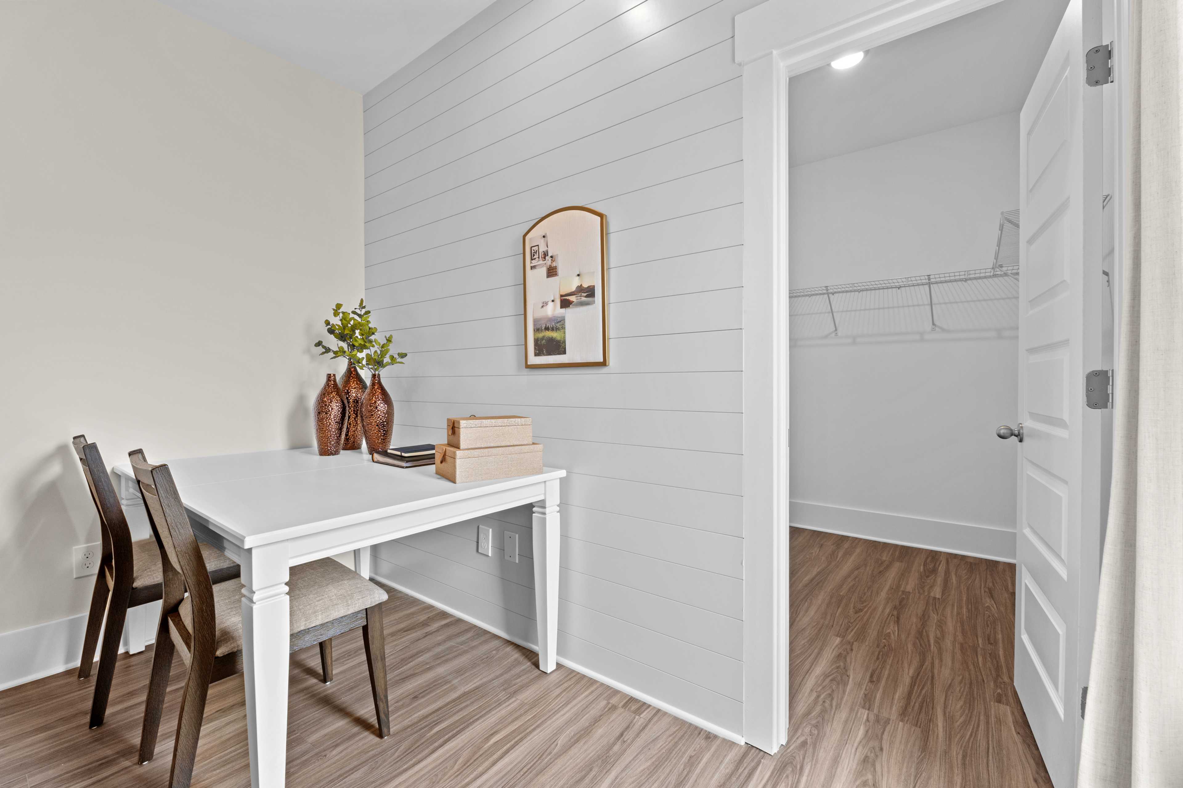 Cozy home office at Ivy Hills in Toney Alabama with white shiplap walls, desk, chairs, and open walk-in closet