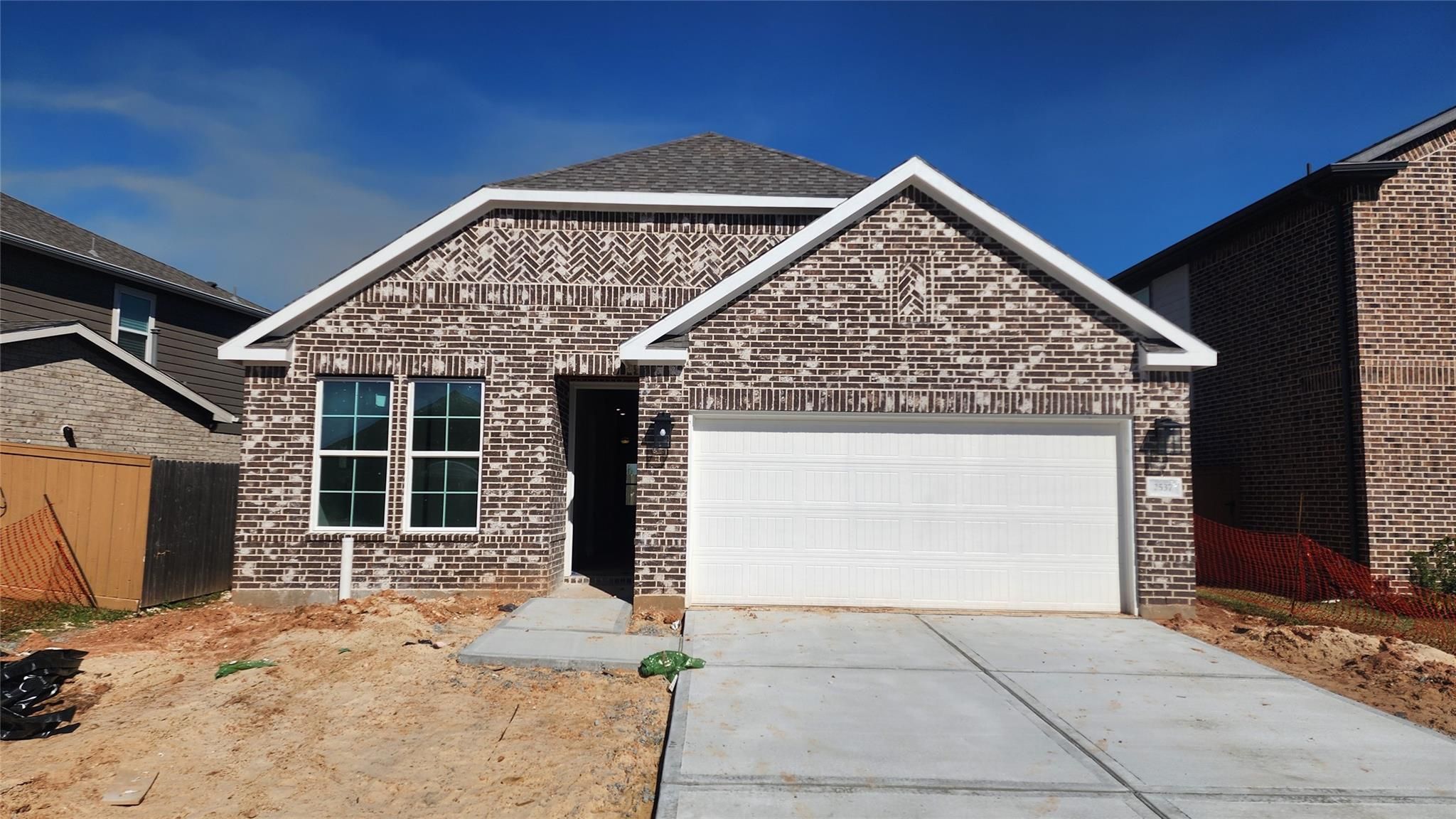 Modern single-story brick home with 2-car garage, Davidson Homes The Luna J in Sunterra, Katy, Texas
