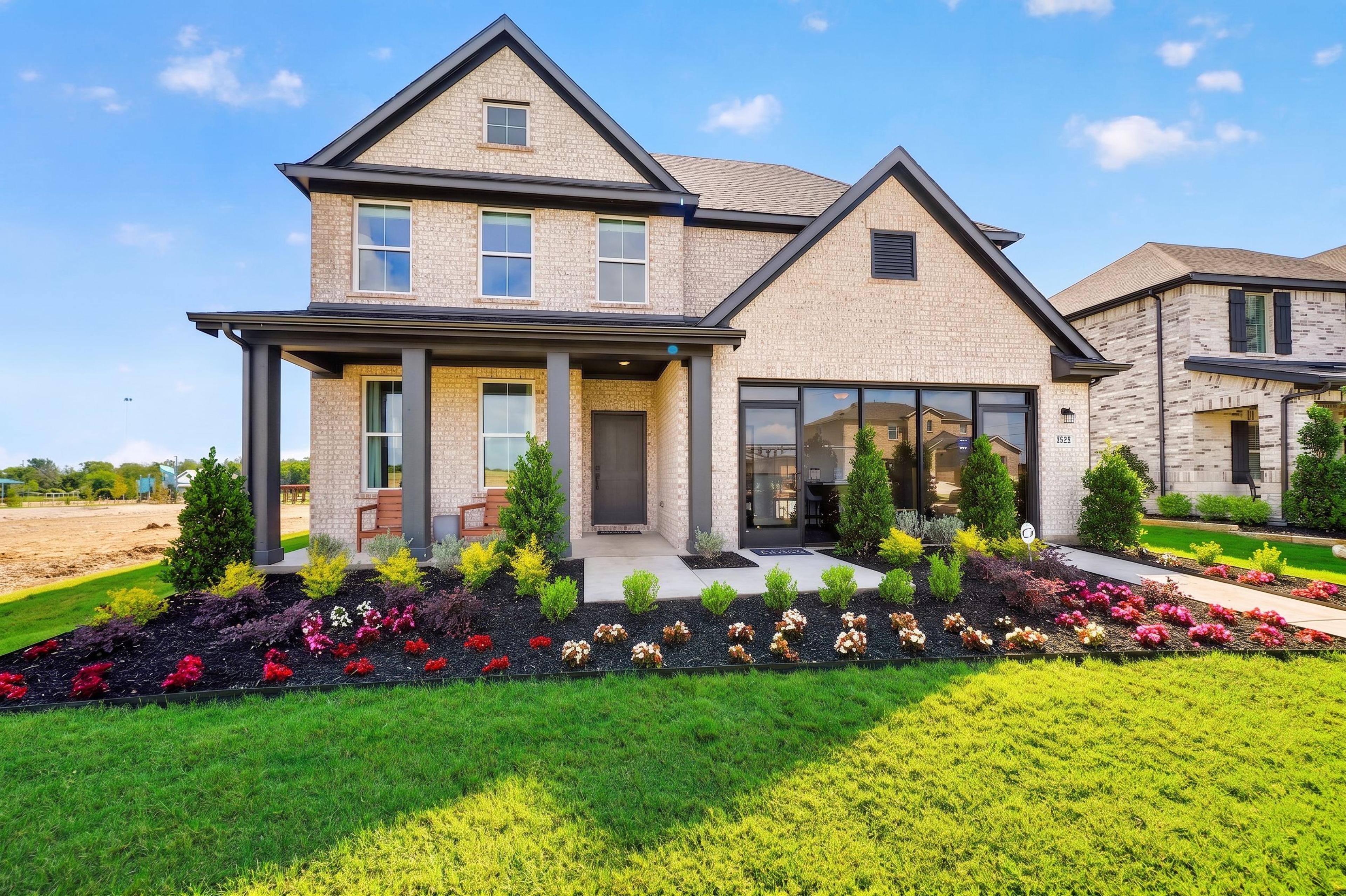 Davidson Homes exterior featuring brick and stone facade at The Parks at Foster Crossing in Anna, Texas.
