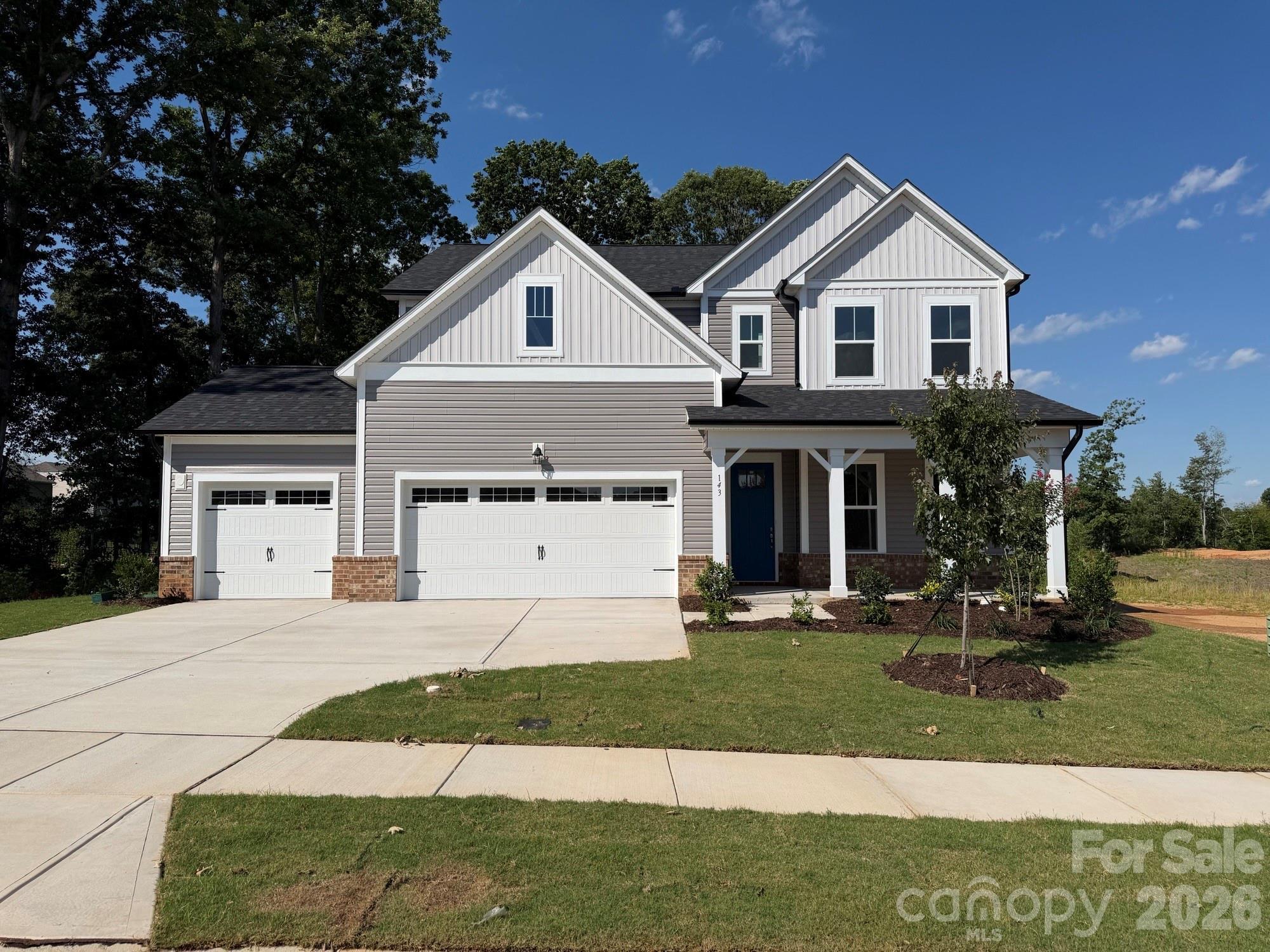 Two-story Hickory B II home by Davidson Homes with a 3-car garage in Windgate, Mooresville, North Carolina.