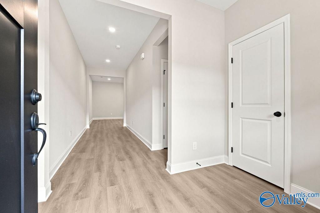 Bright, modern entryway with wood-look flooring in The Camilla C floor plan at The Retreat at Cain Park, Hartselle.