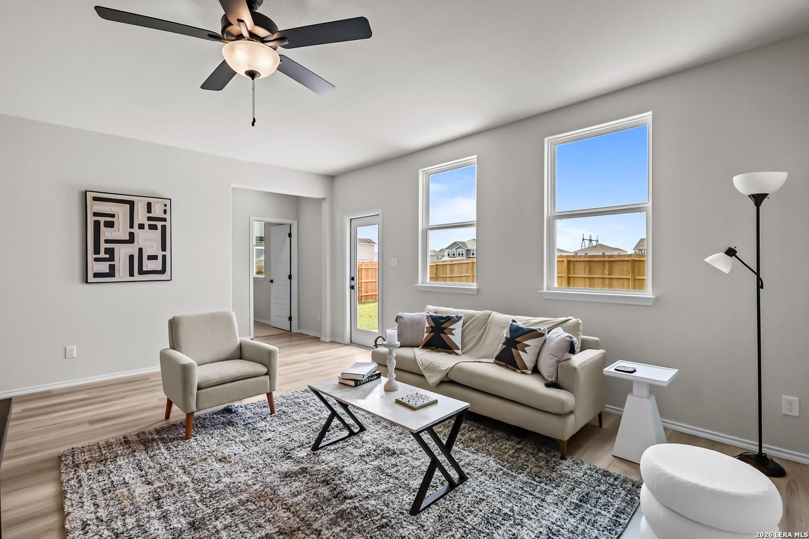 Bright living room with modern decor in The Douglas C floor plan at Hannah Heights, Seguin, Texas.