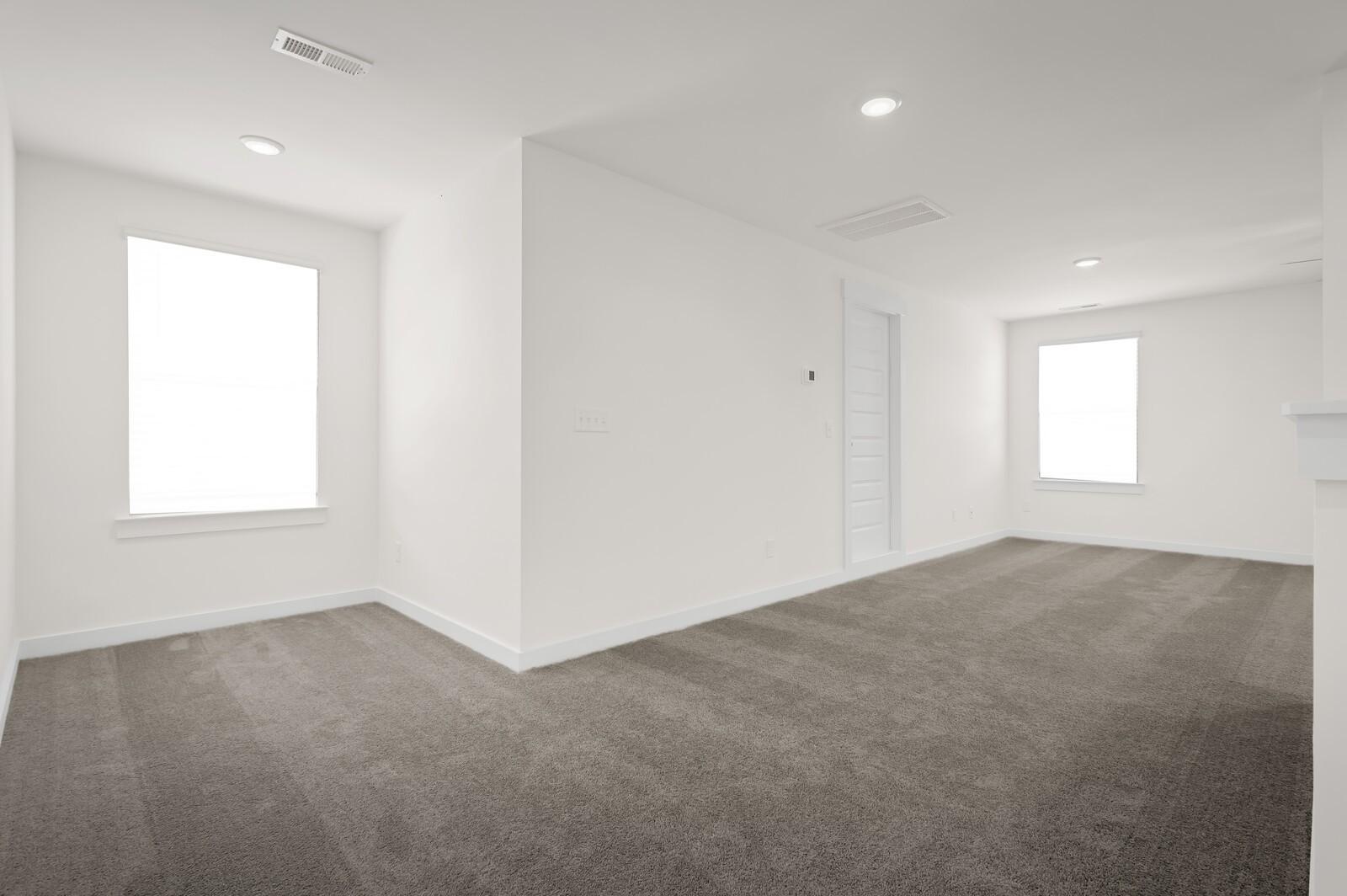 Bright, carpeted loft or flex space in The Ash A floor plan by Davidson Homes in Woods Crossing, Gallatin, Tennessee.