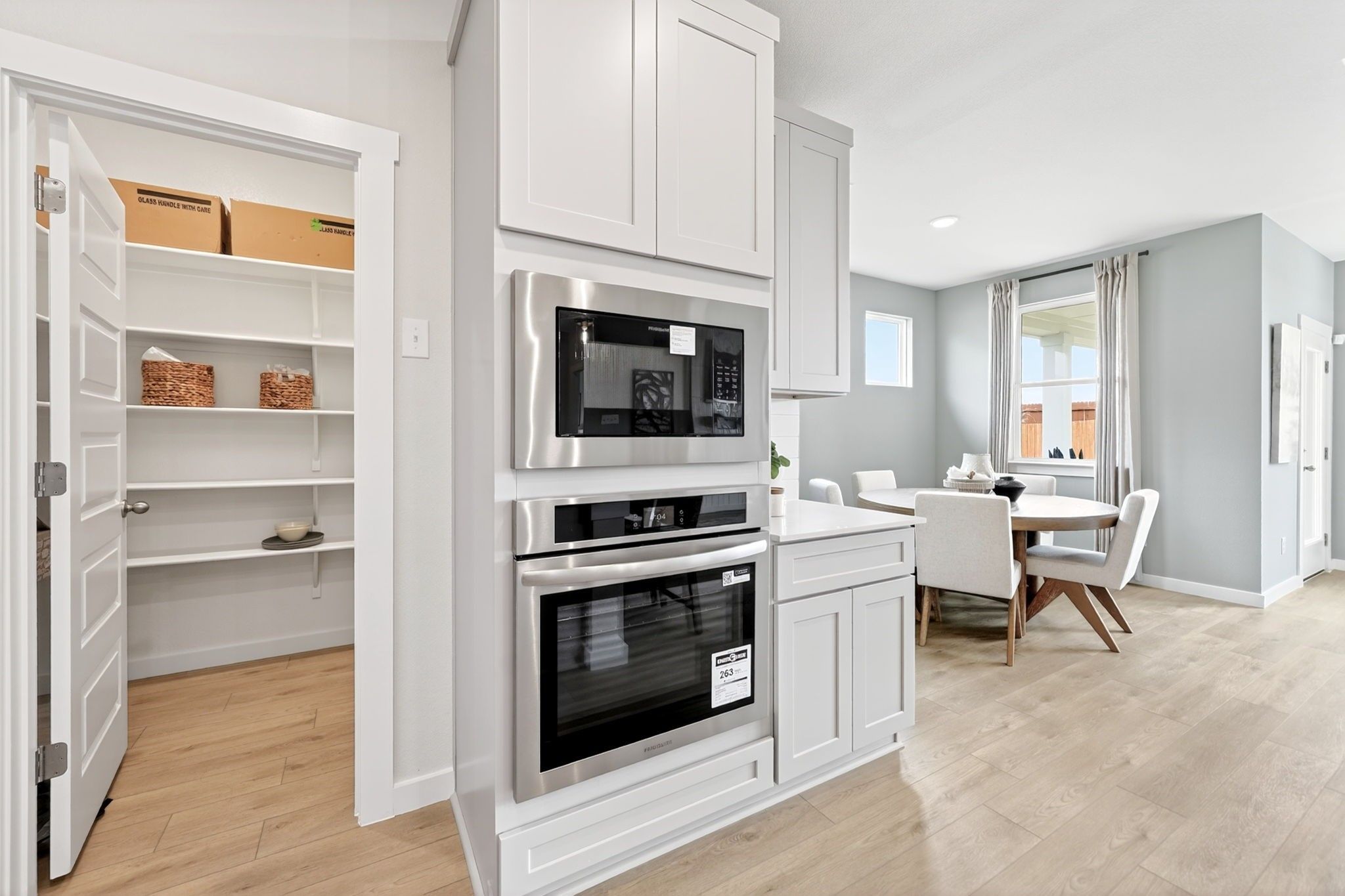 Built-in stainless oven and microwave in The Laurel O floor plan by Davidson Homes in Parks at Foster Crossing, Anna, TX.