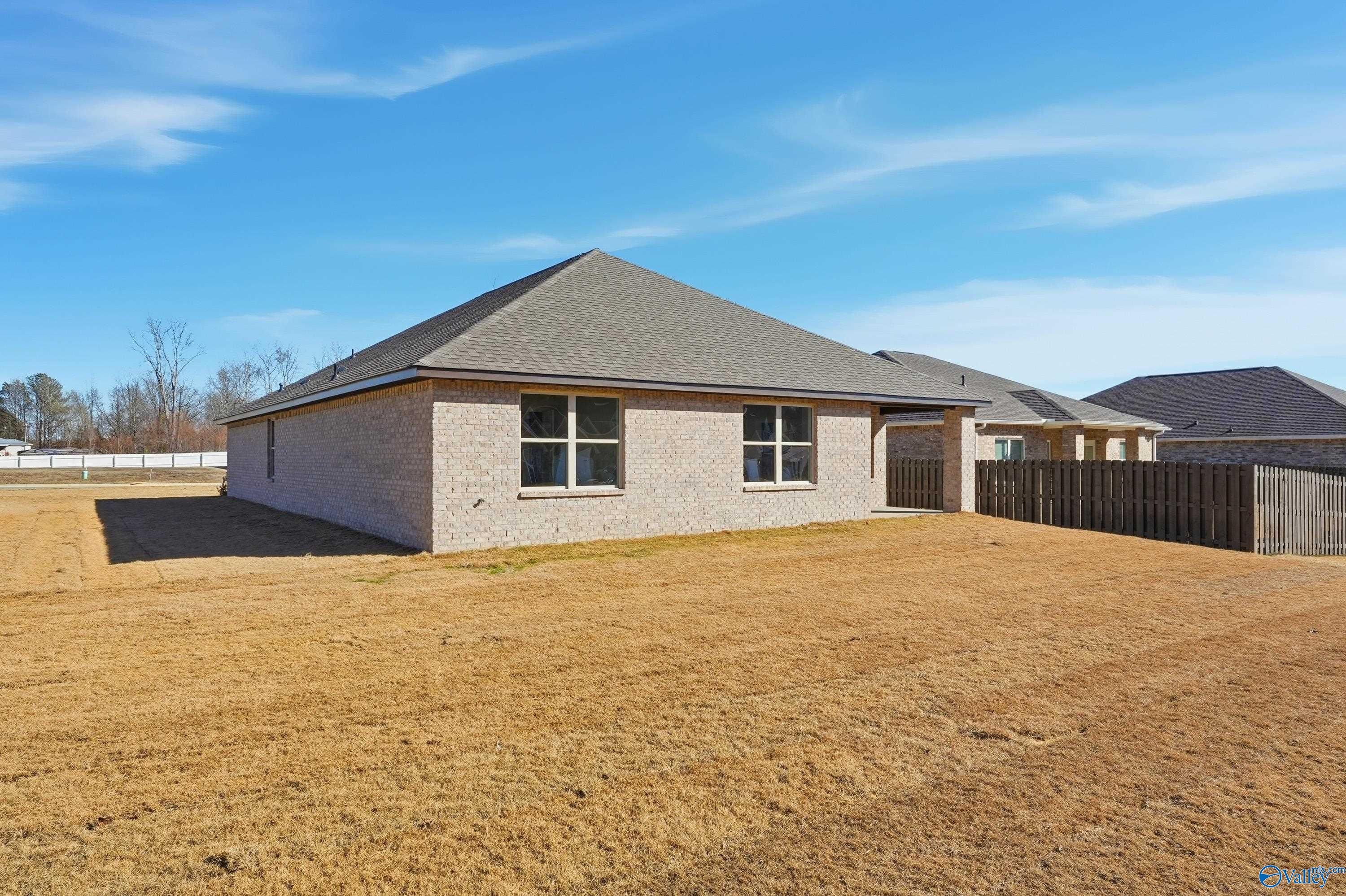 Single-story brick home with 2-car garage, fenced yard, and gable roof in The Highlands, Arab, Alabama - Daphne C by Davidson Homes