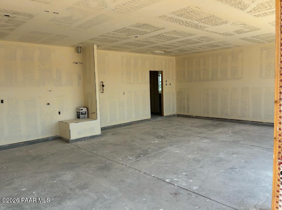 Unfinished interior of 3-car garage under construction in The Boulder II F floor plan, South Ranch, Prescott, Arizona.