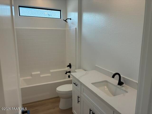 White bathroom with tub, toilet, and vanity with black fixtures in Davidson Homes Durango II G, Prescott, Arizona